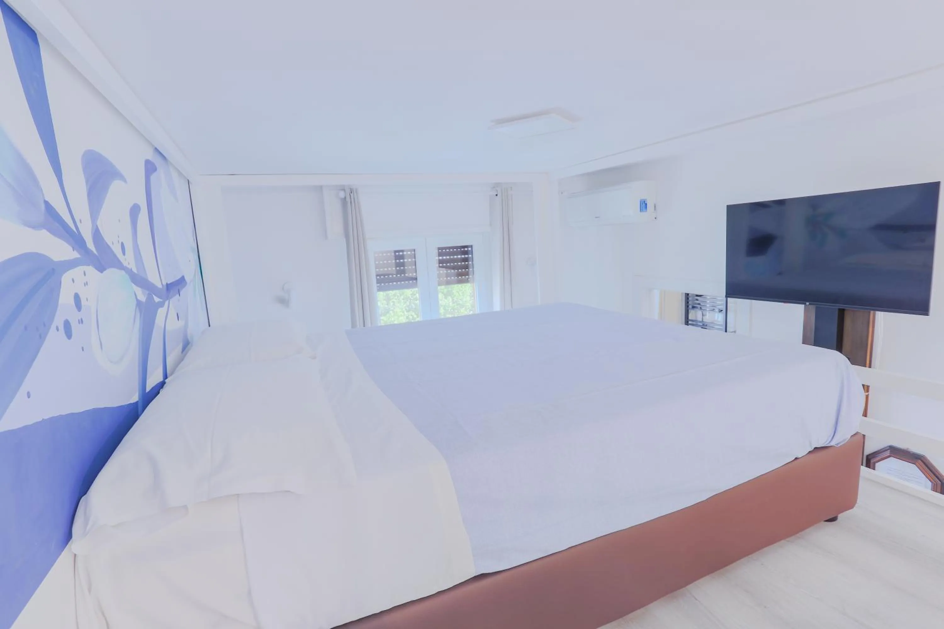 Bed in HOLABOLOGNA Luxury Rooms and Flats