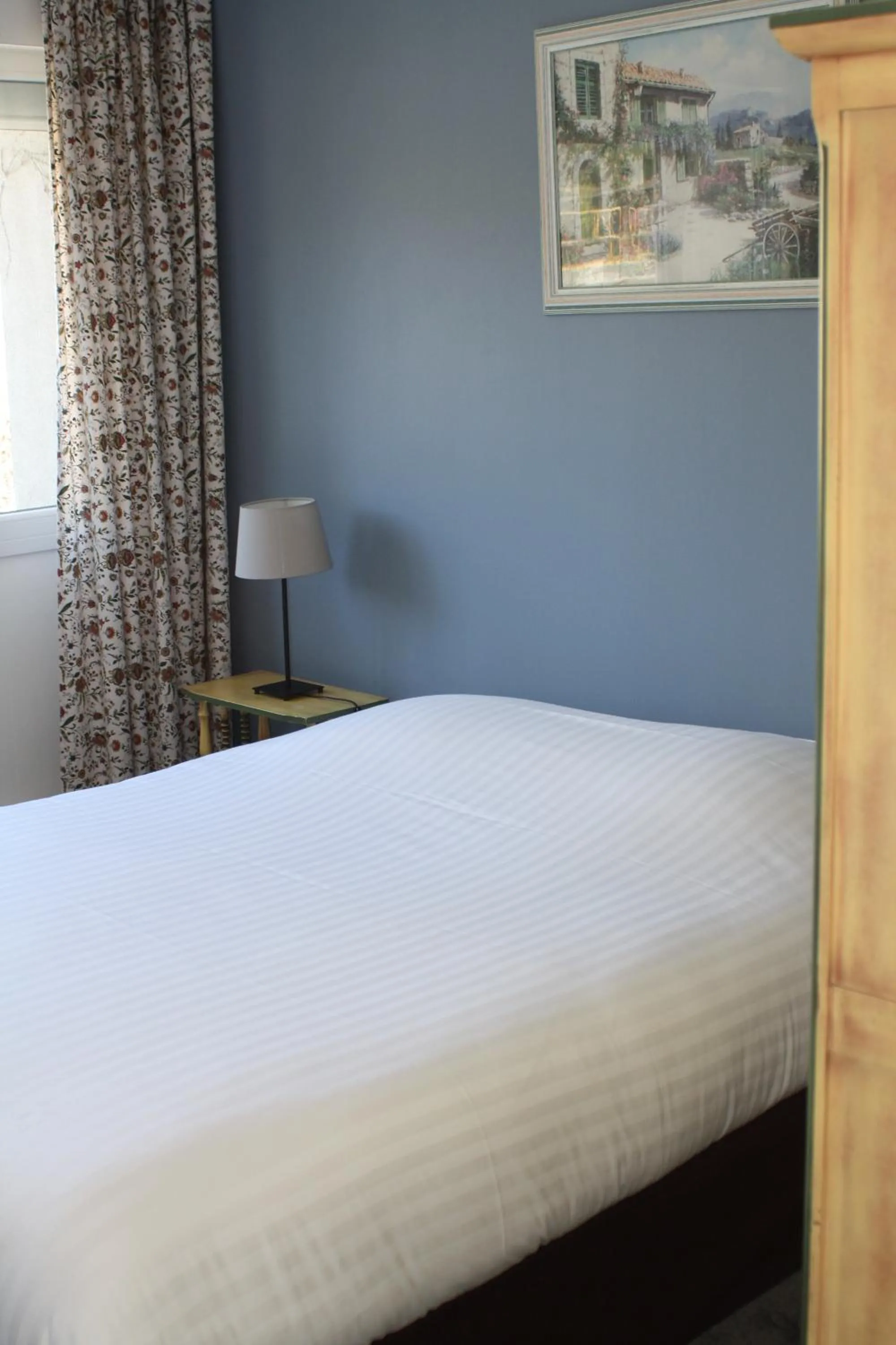 Bed in Logis Hotel du Midi