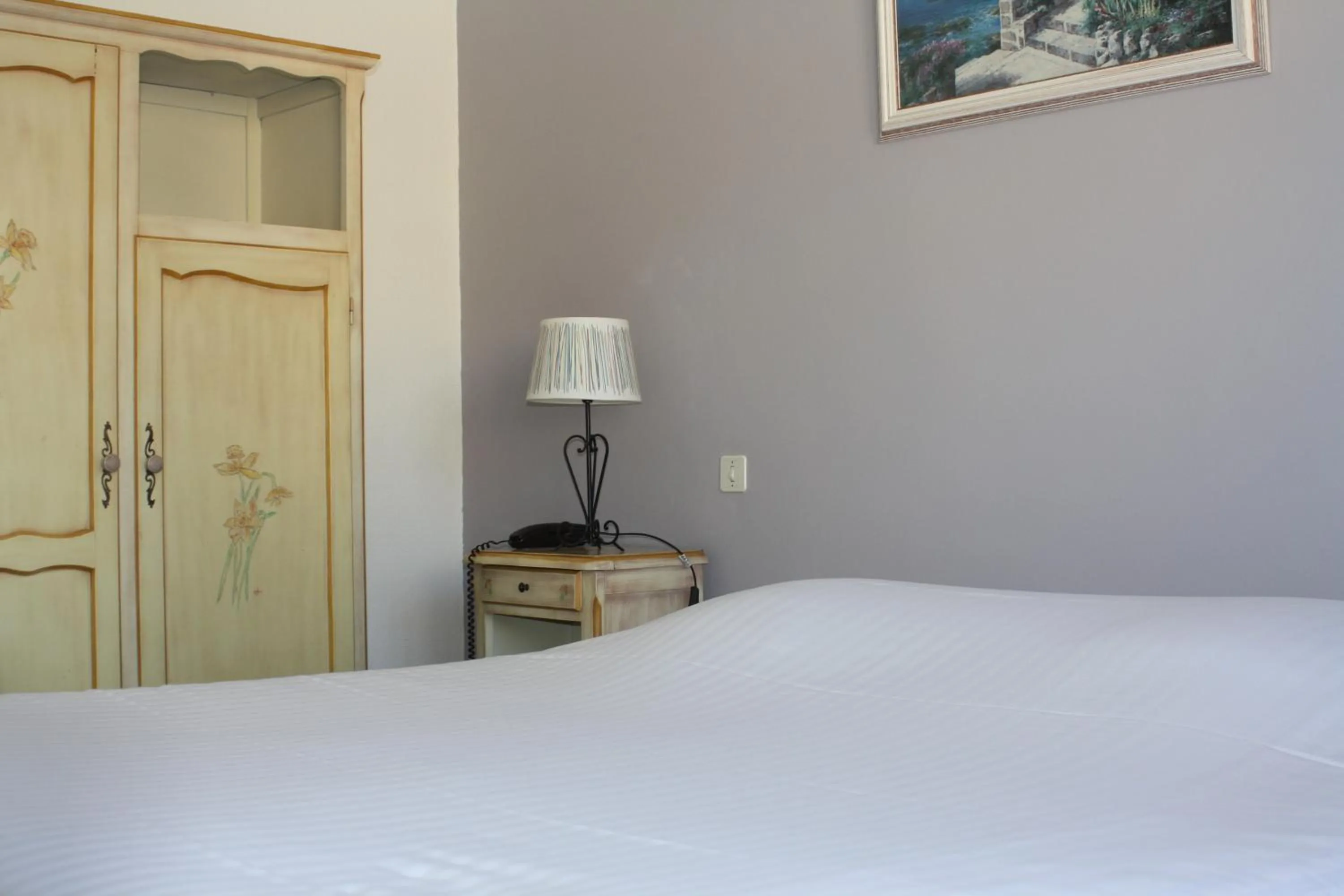 Bed in Logis Hotel du Midi