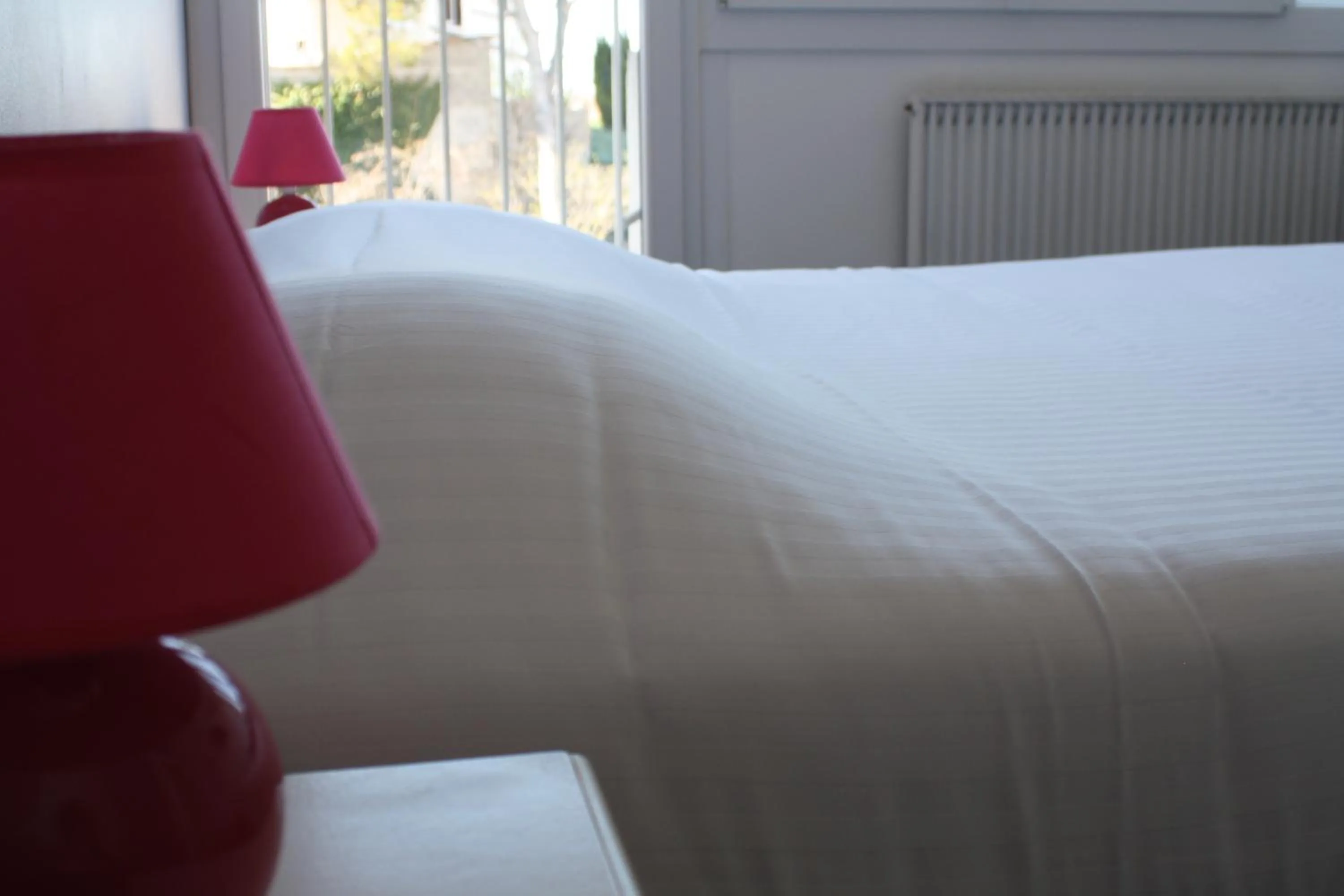 Bed in Logis Hotel du Midi