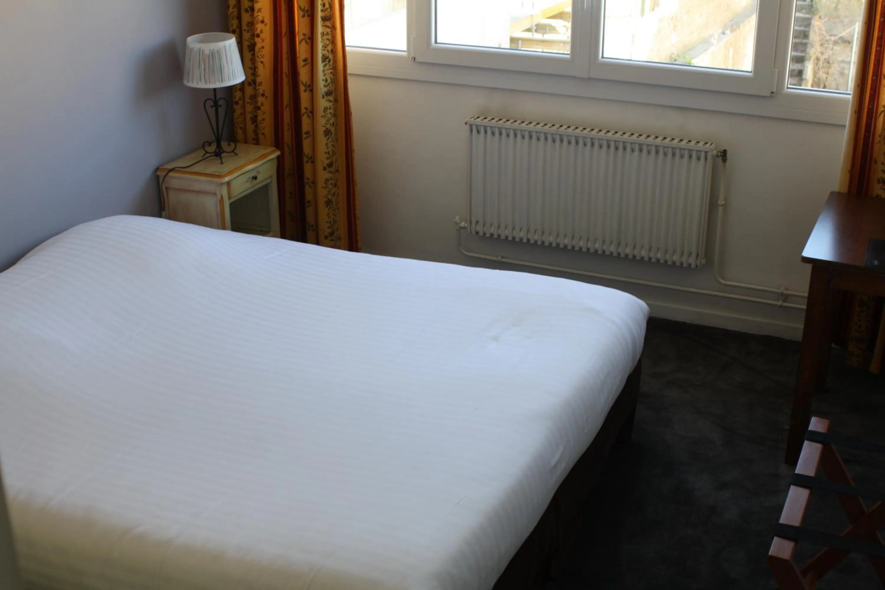 Bed in Logis Hotel du Midi