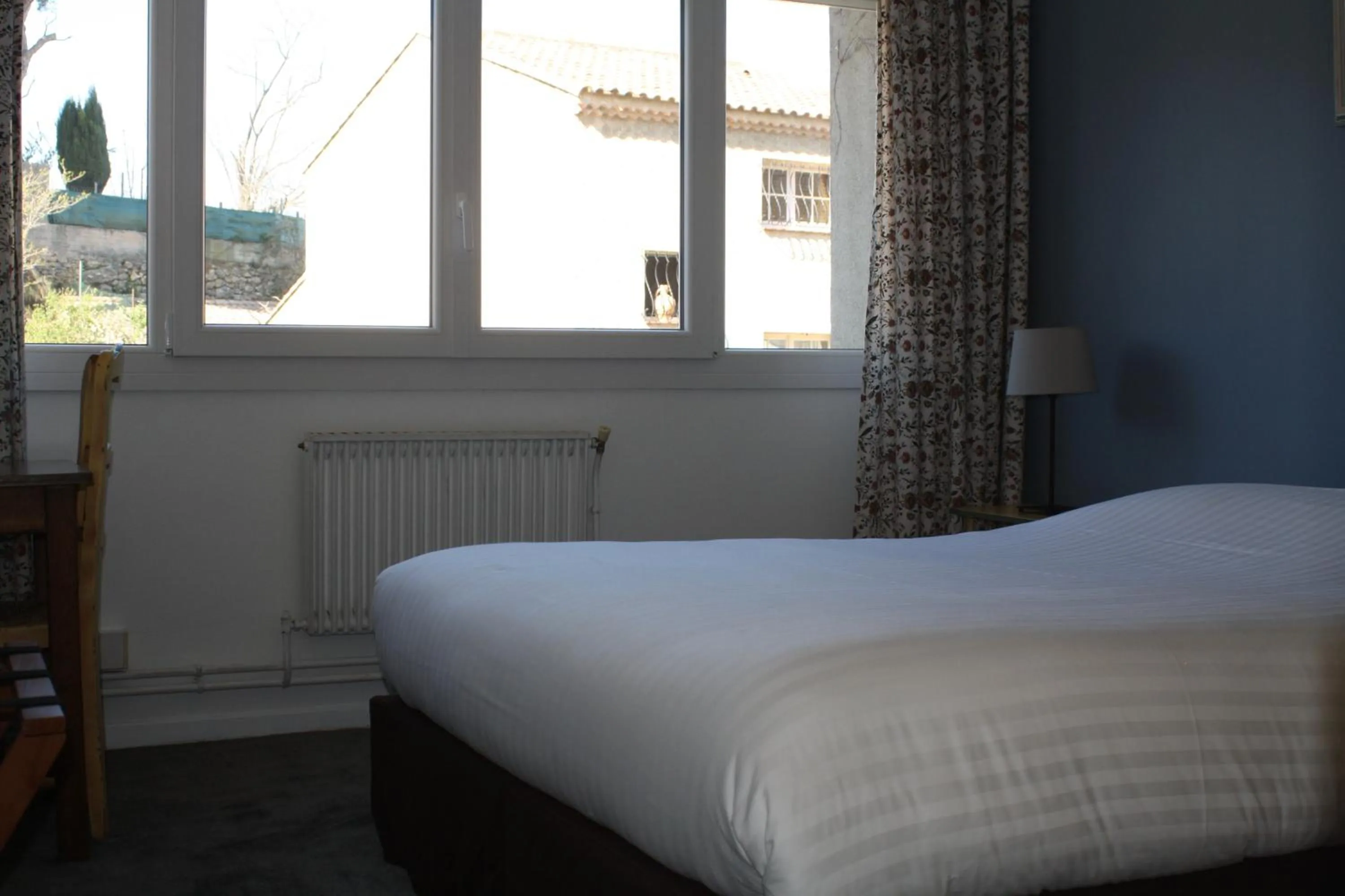 Bed in Logis Hotel du Midi