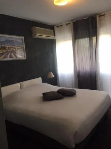 Bed in Logis Hotel du Midi