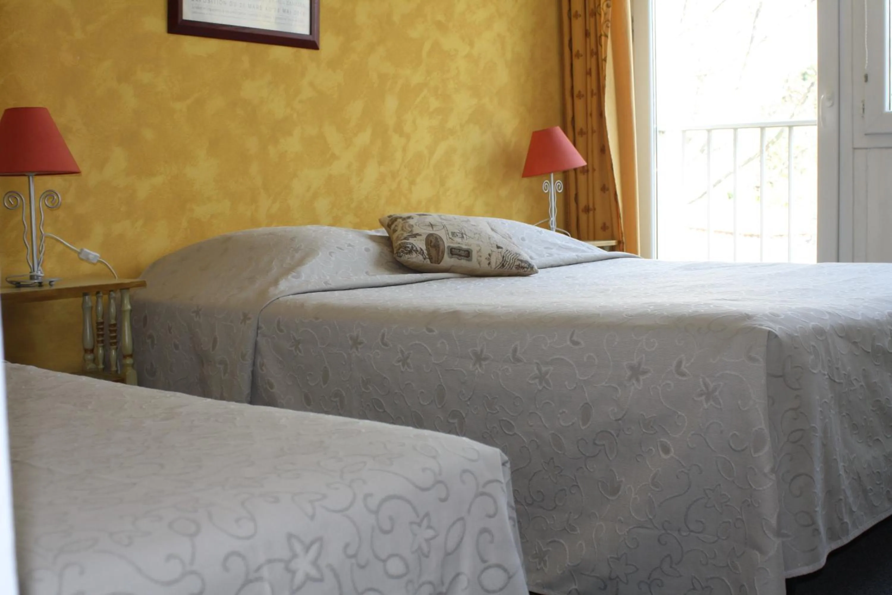 Bed in Logis Hotel du Midi