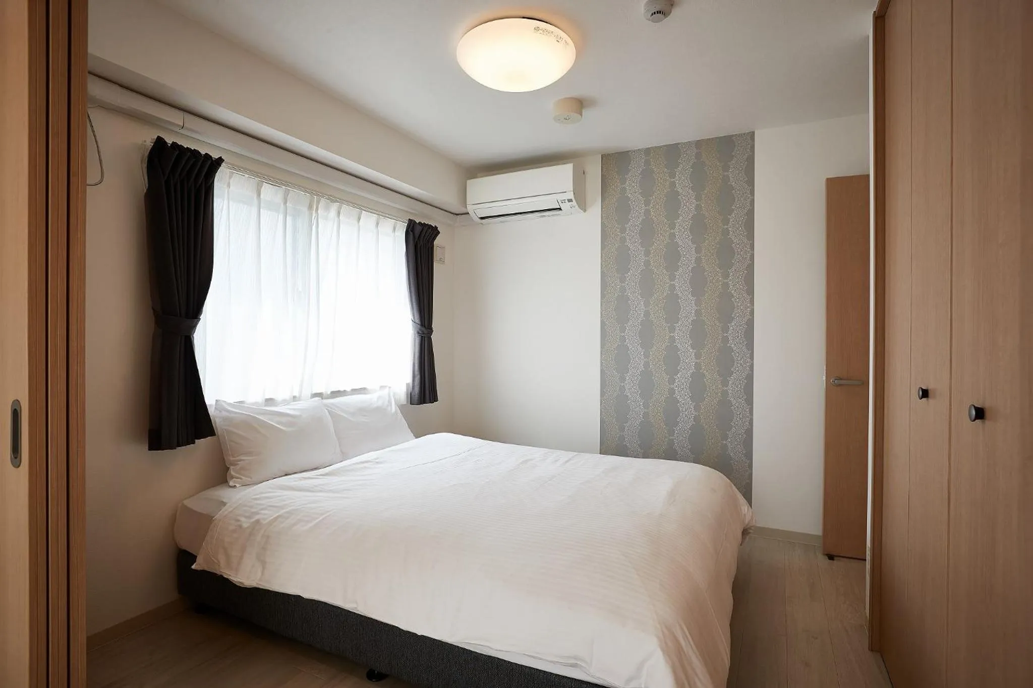 Bedroom, Bed in New Normal Hotel in NAGO ニューノーマルホテルイン名護