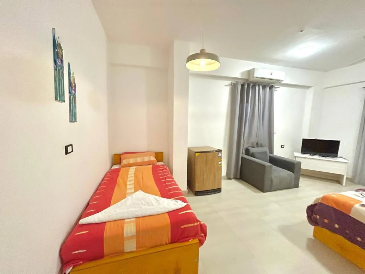 Communal lounge/ TV room, Bed in Nile Panorama Hotel & Restaurant