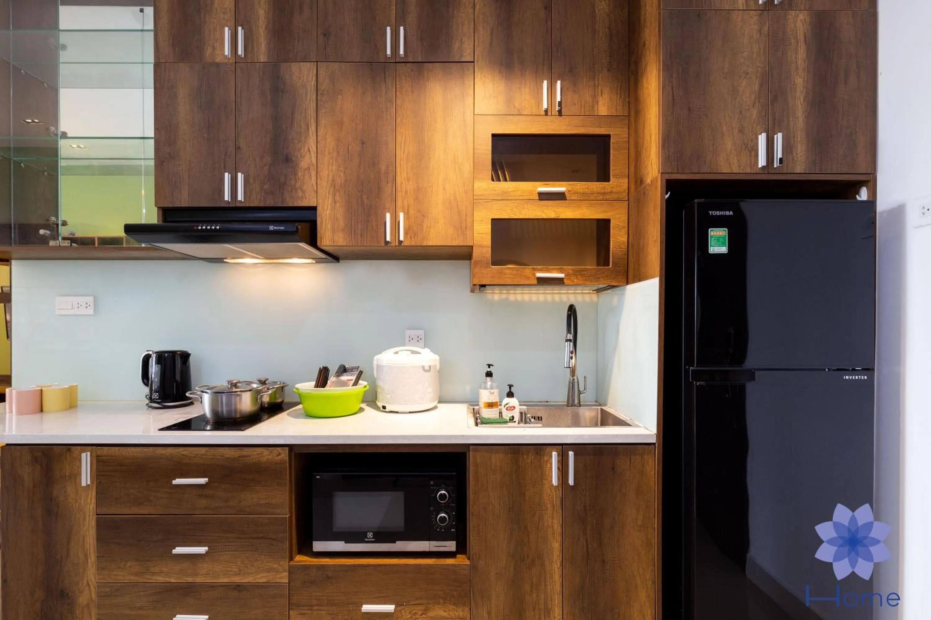 stove in iHome Furnished Apartments with Free Gym & Pool, Airport Pick-Up Service