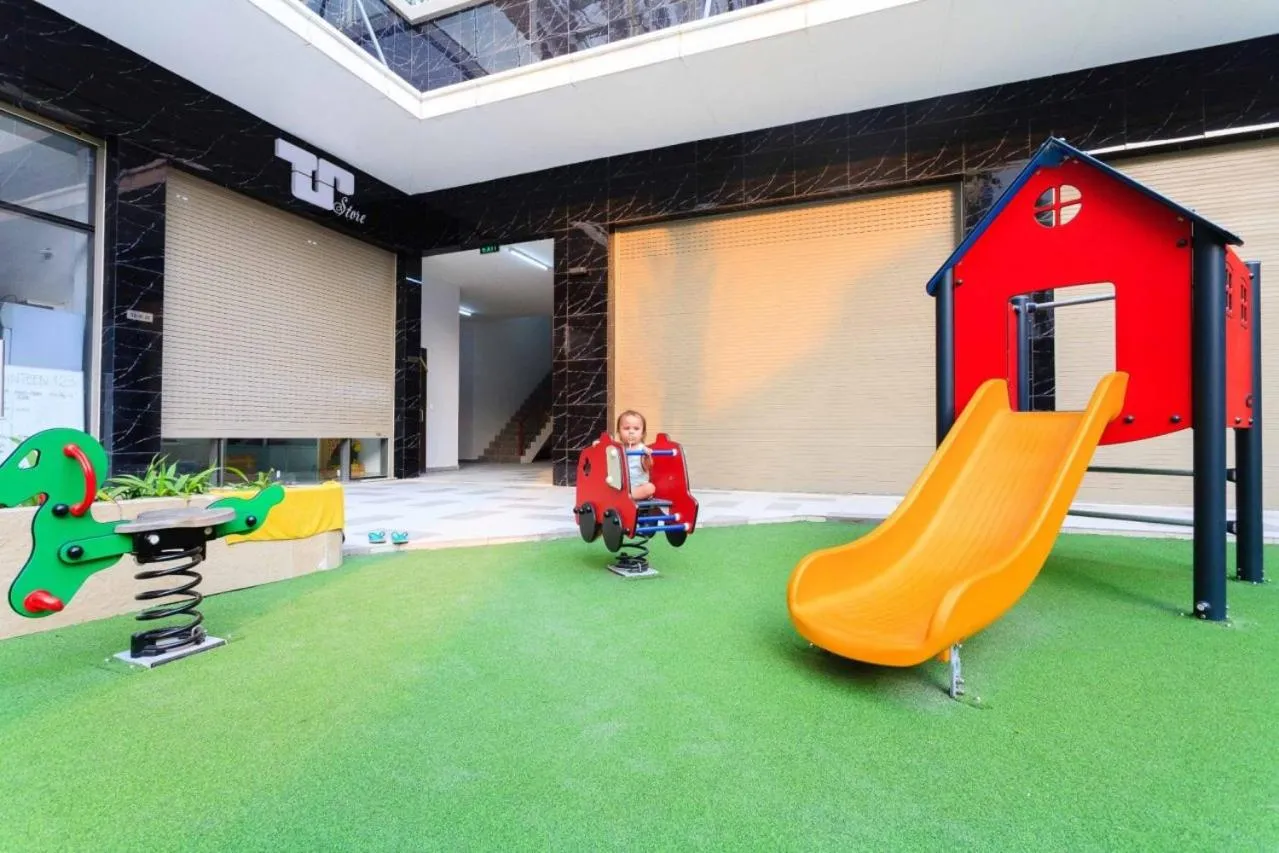 Children play ground in iHome Furnished Apartments with Free Gym & Pool, Airport Pick-Up Service