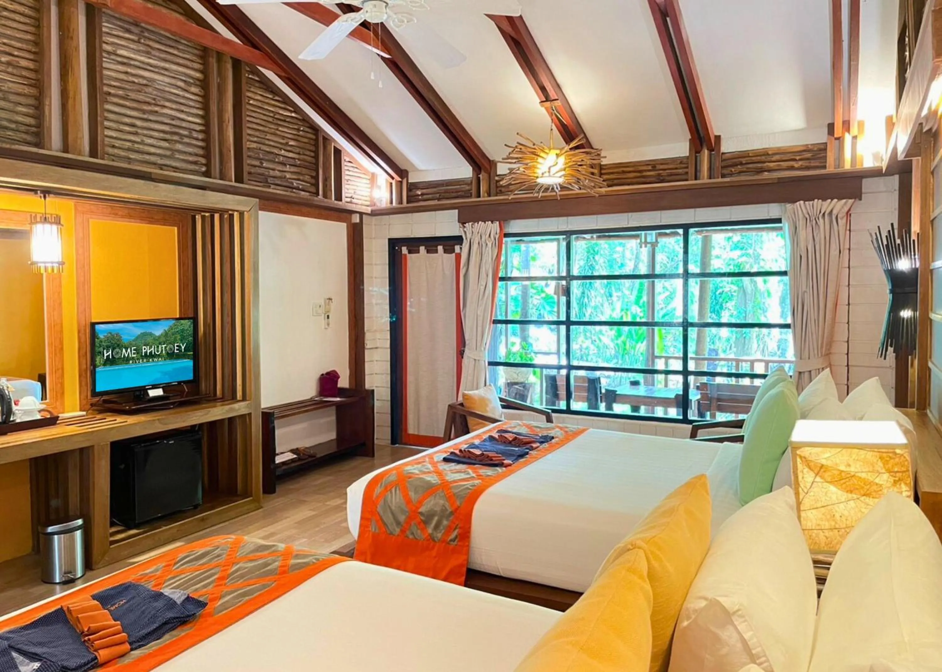 Photo of the whole room, Bed in Home Phutoey River Kwai Hotspring & Nature Resort