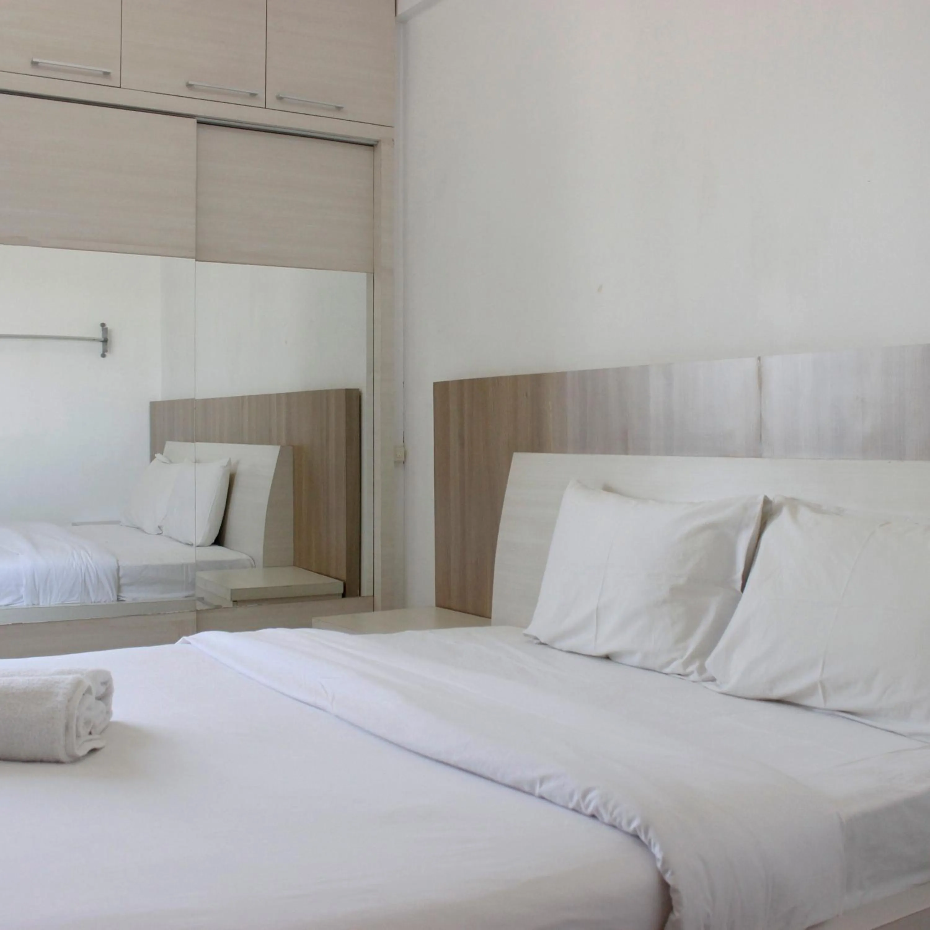 Bed in Minimalist Studio Apartment at The Suite @Metro By Travelio