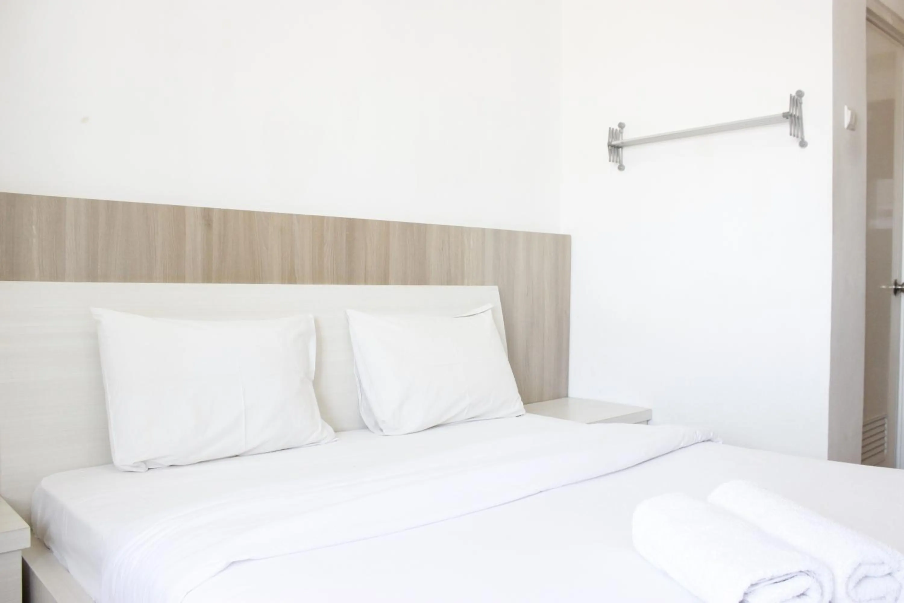 Bed in Minimalist Studio Apartment at The Suite @Metro By Travelio