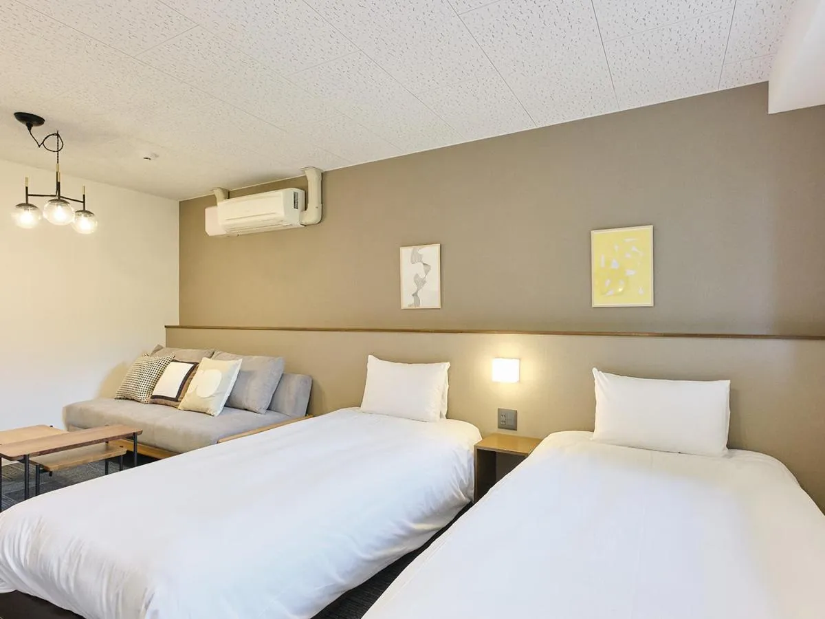 Bed in UCHI Living Stay Otaru Suitengu