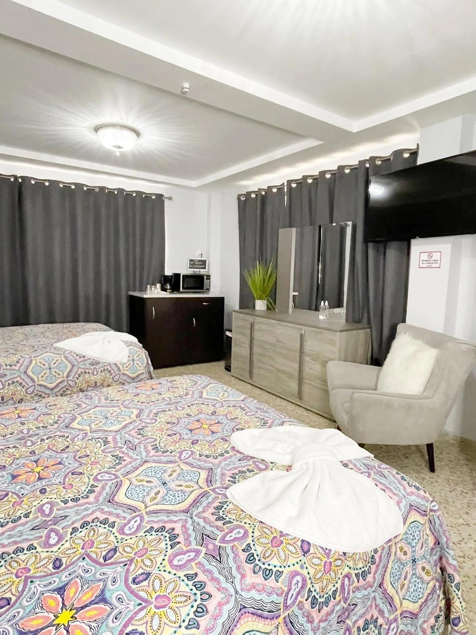 Bed in Itza-Bella Suites