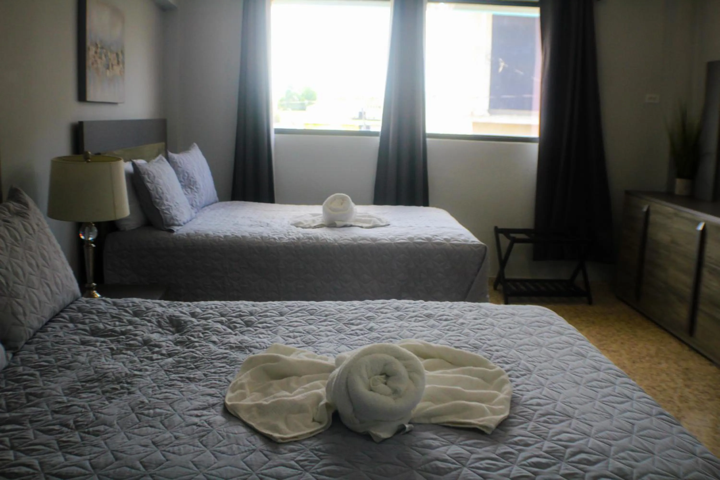 Bed in Itza-Bella Suites