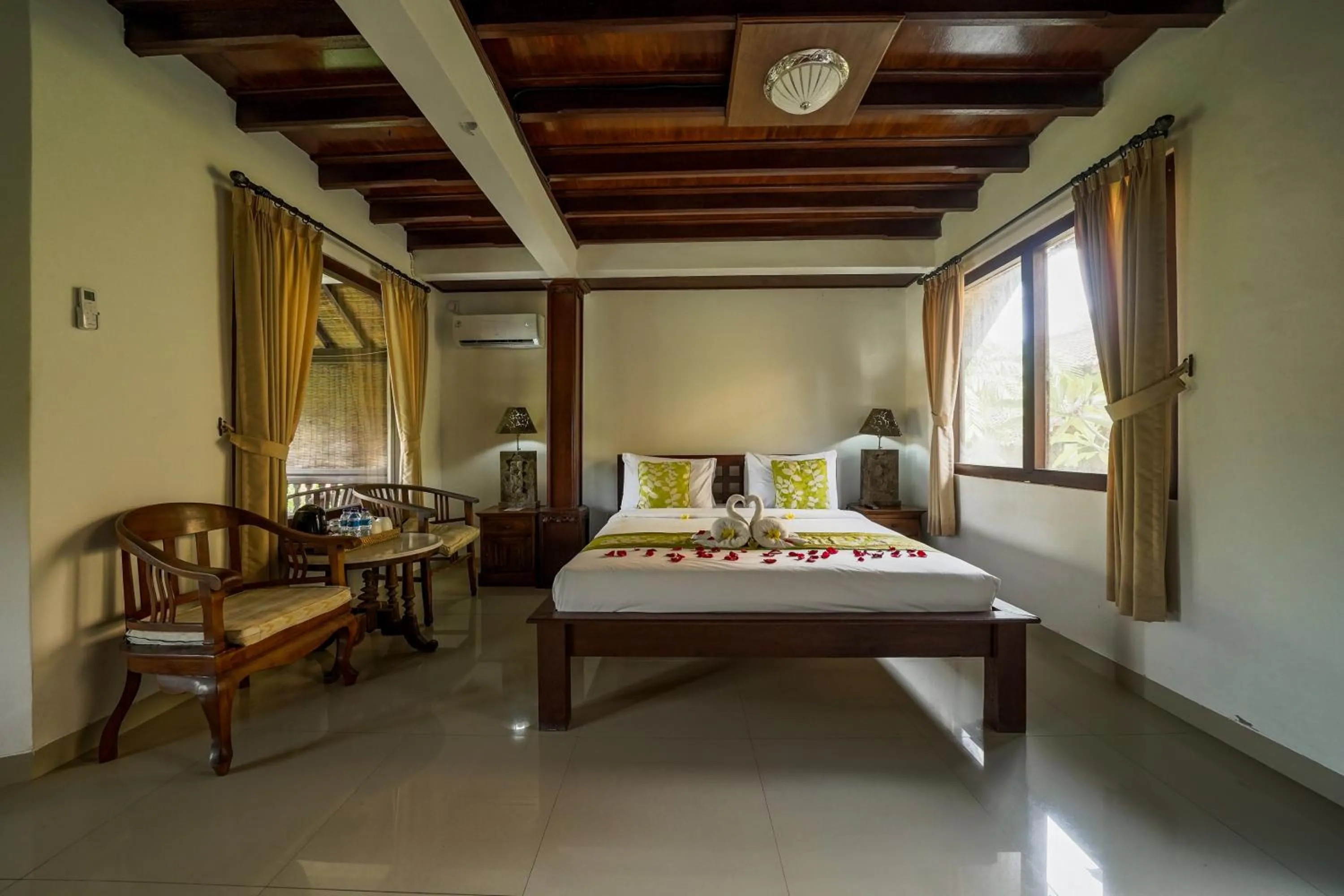 Bed in Three Brothers Bali Legian Bungalows & Villas