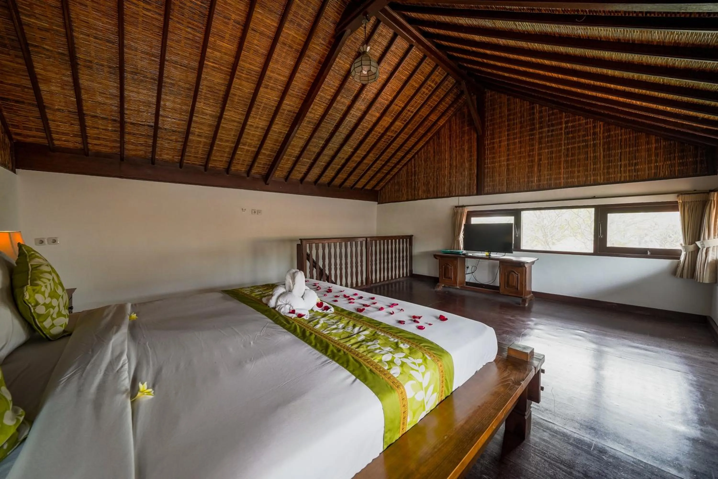 Bed in Three Brothers Bali Legian Bungalows & Villas