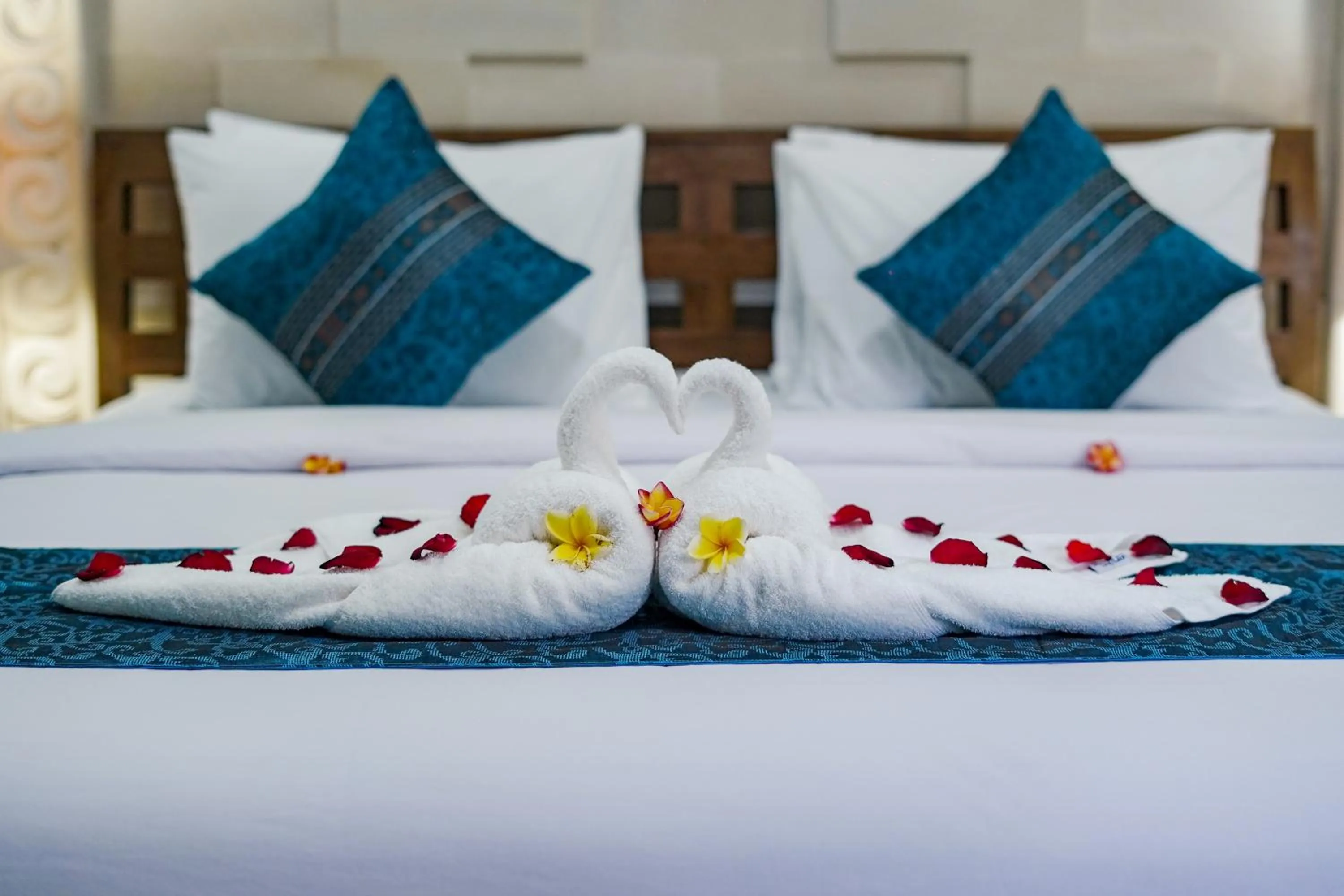 Bed in Three Brothers Bali Legian Bungalows & Villas