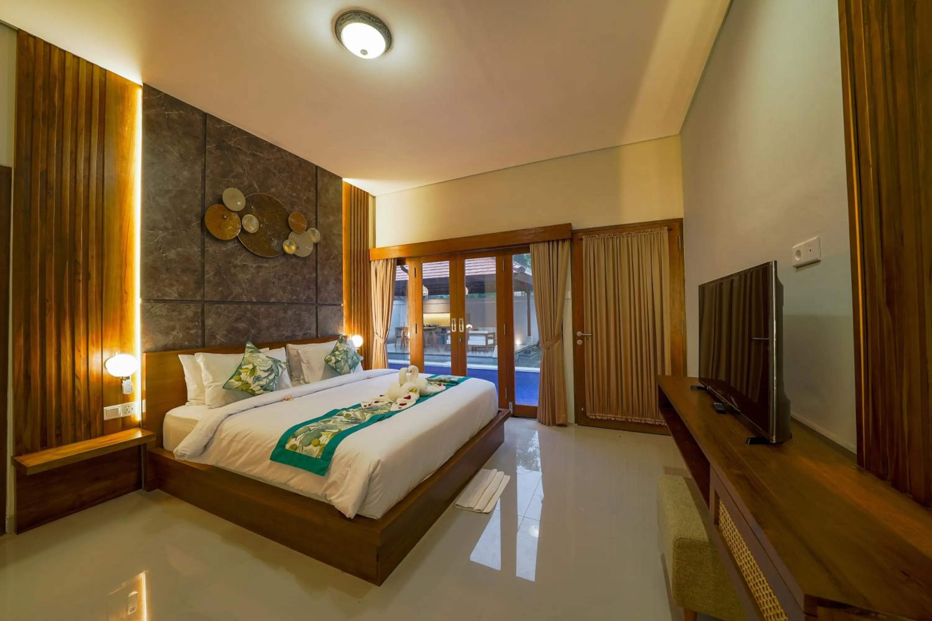 Bed in Three Brothers Bali Legian Bungalows & Villas