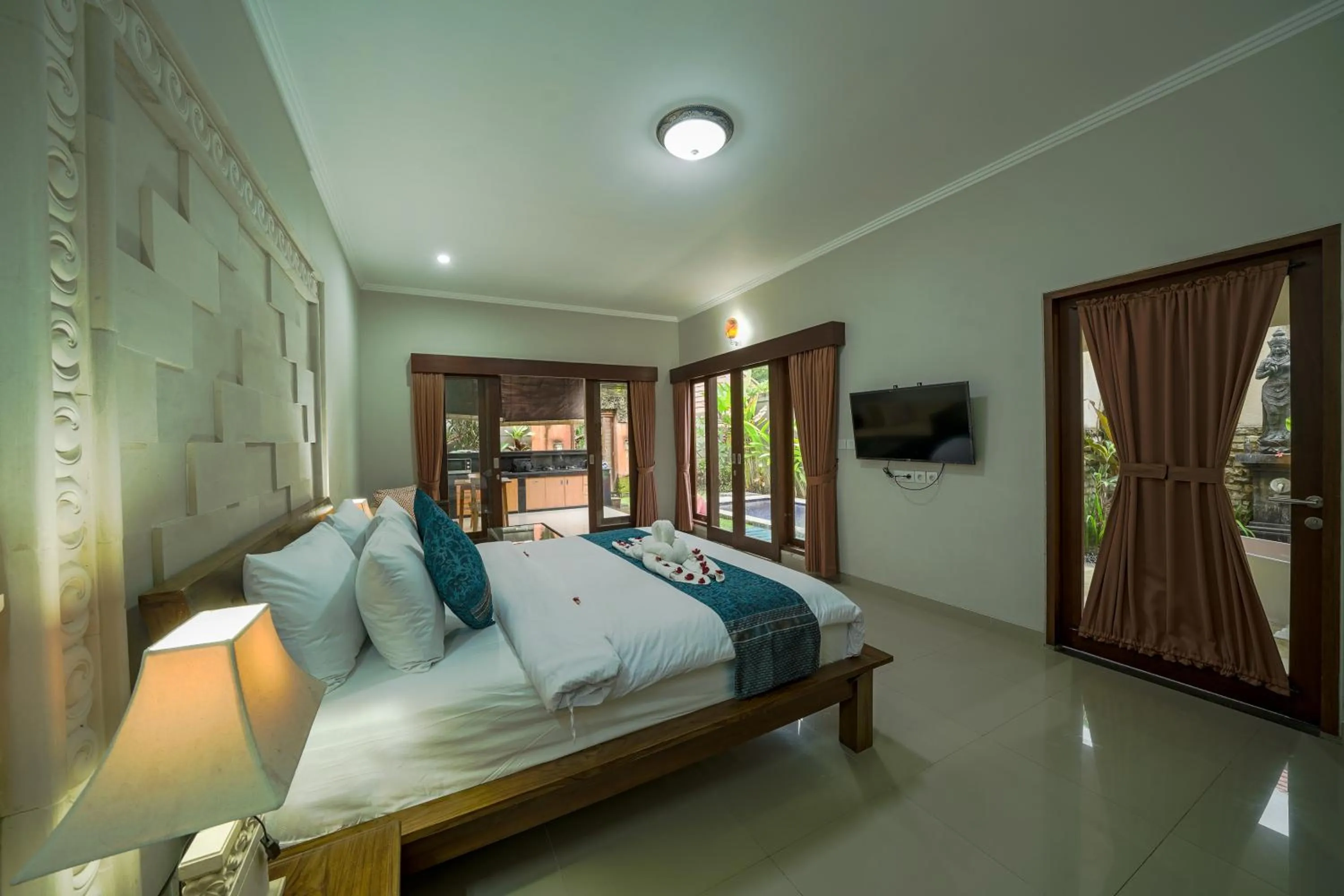 Bed in Three Brothers Bali Legian Bungalows & Villas