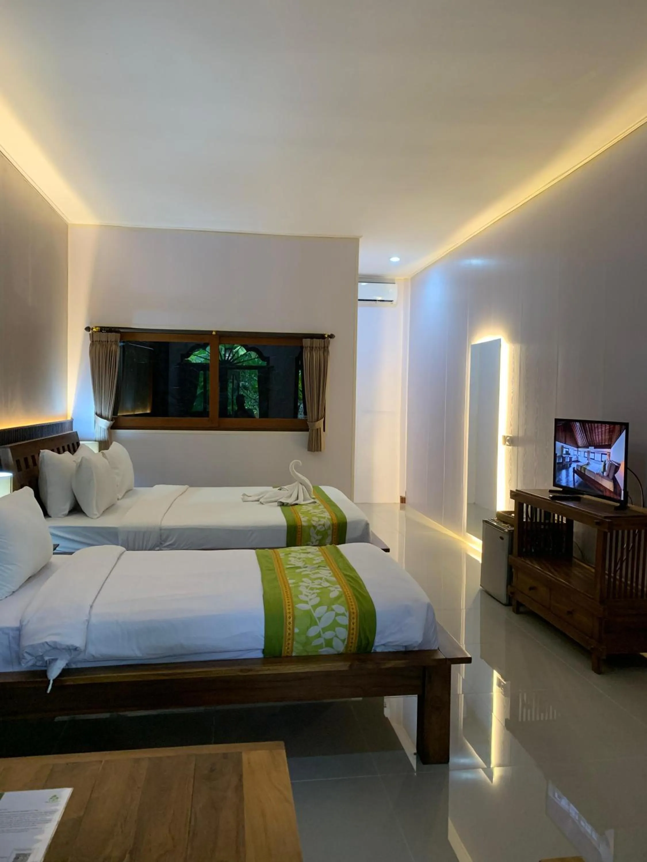 Bed in Three Brothers Bali Legian Bungalows & Villas