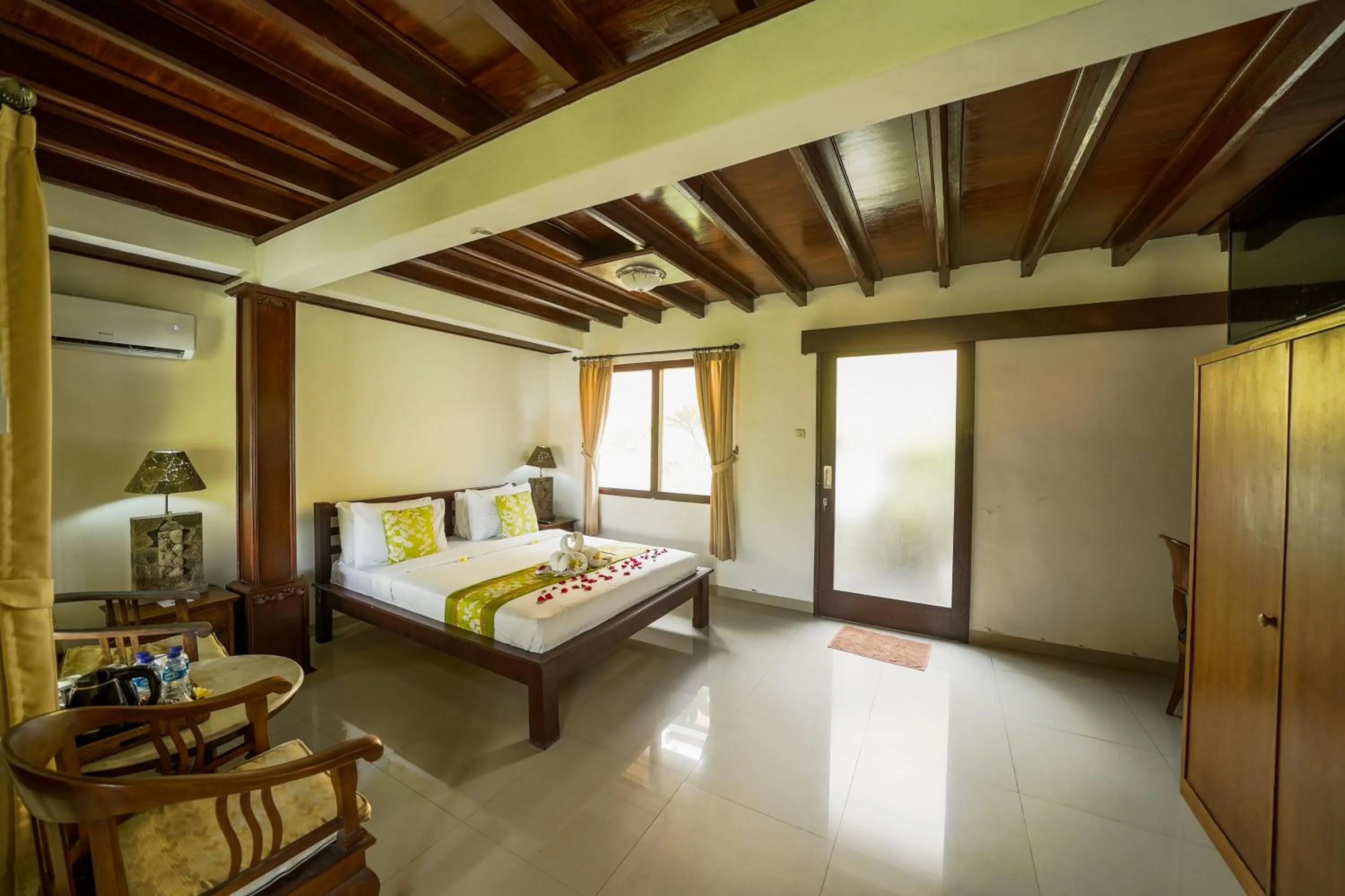 Bed in Three Brothers Bali Legian Bungalows & Villas