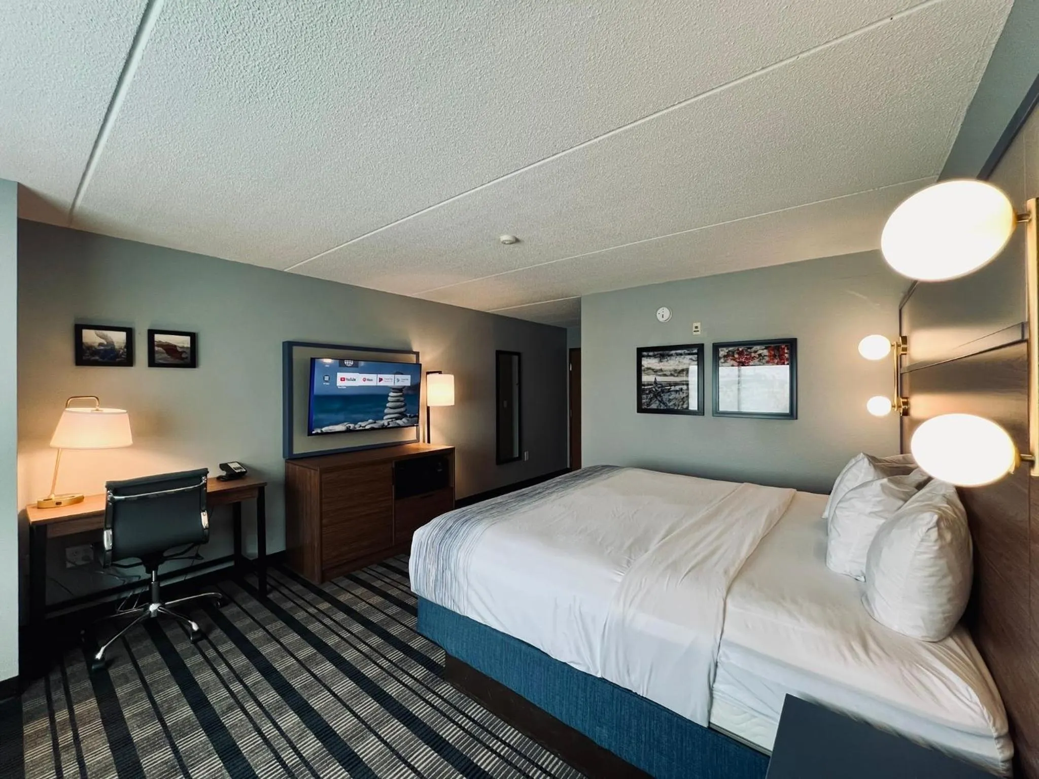 Bed in AmericInn by Wyndham Beaver Dam