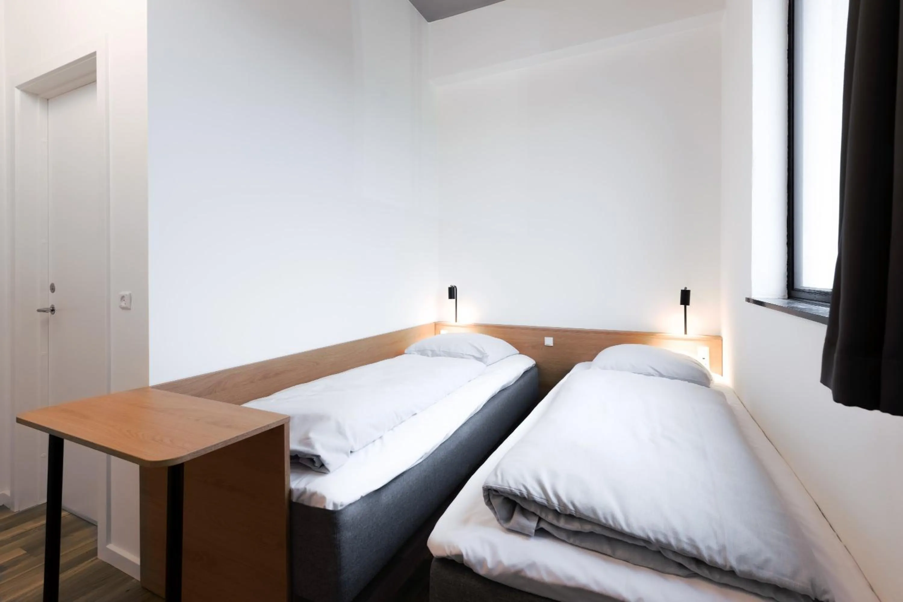 Bed in BOOK1 by Brøchner Hotels