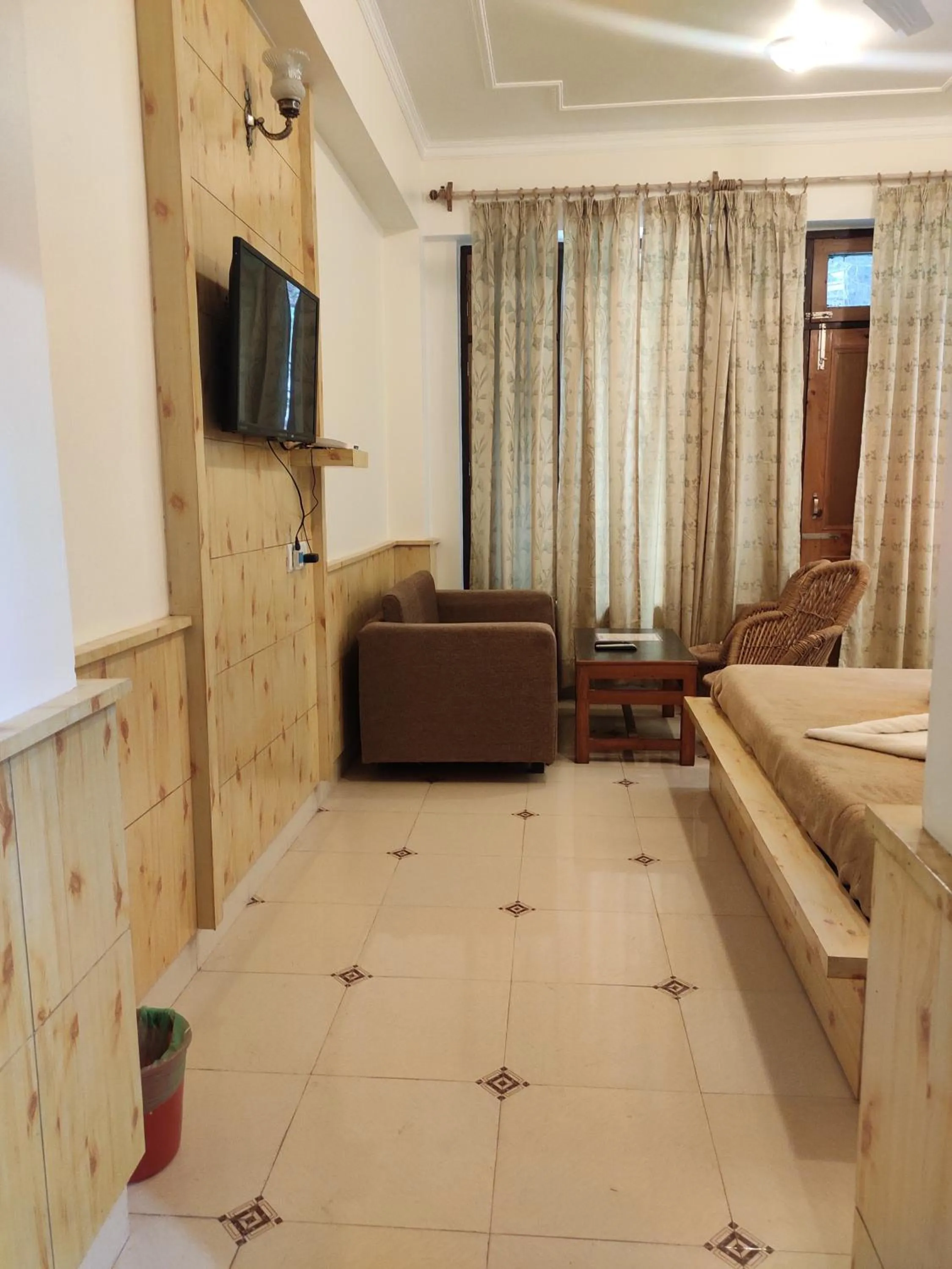 TV and multimedia in Greenwoods Inn Mcleodganj #Parking #lift #All Balcony Rooms #Rooftop Terrace #Prime Location # Close to the Triund Trek Point 400 Mtr Head