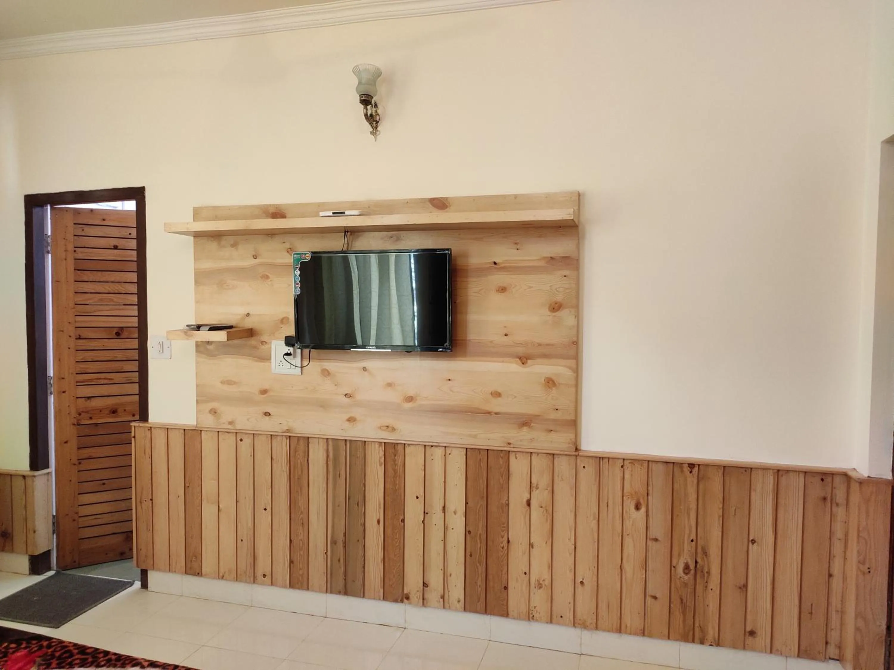 TV and multimedia in Greenwoods Inn Mcleodganj #Parking #lift #All Balcony Rooms #Rooftop Terrace #Prime Location # Close to the Triund Trek Point 400 Mtr Head