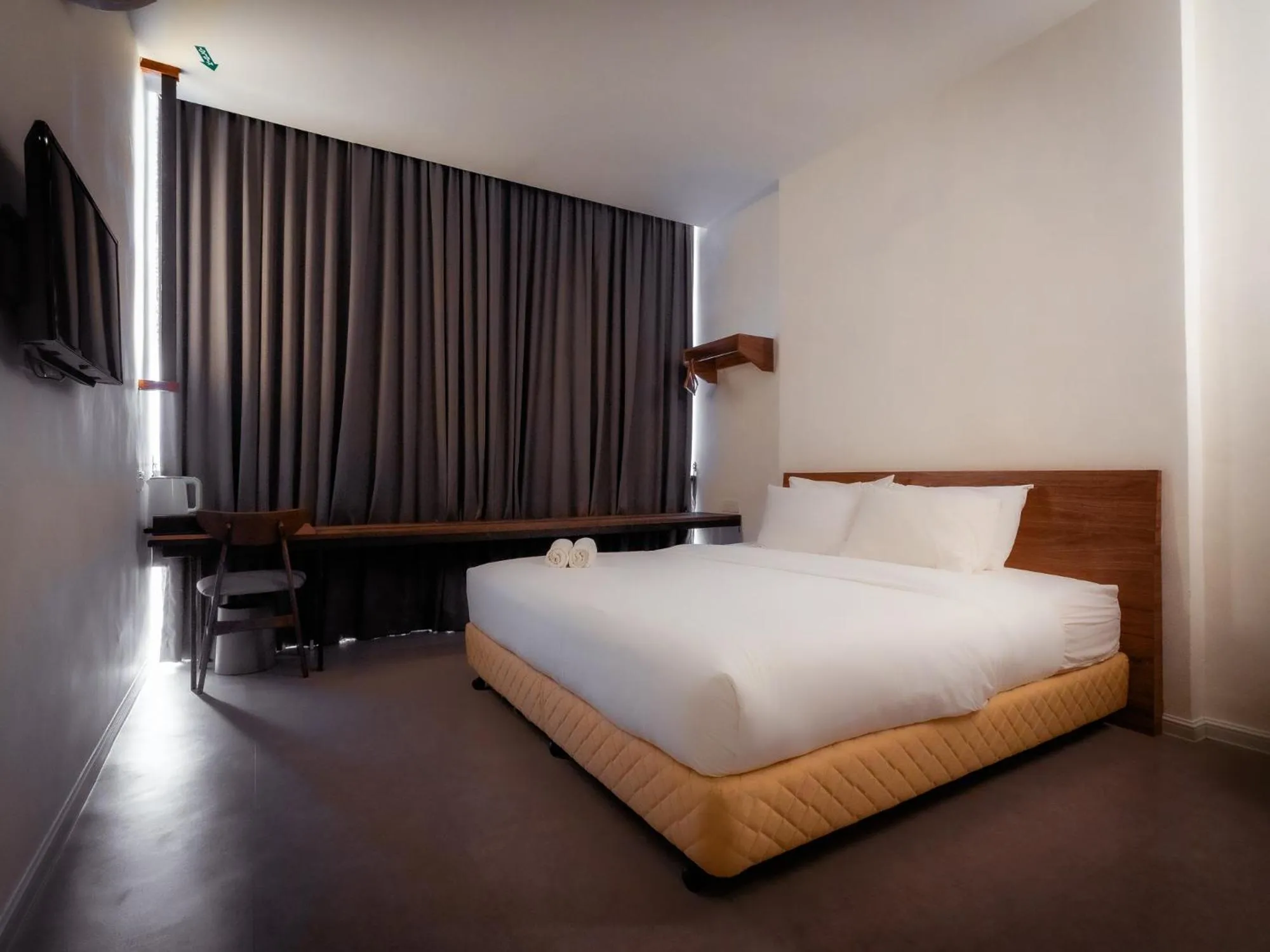 Bed in T+ PREMIUM HOTEL