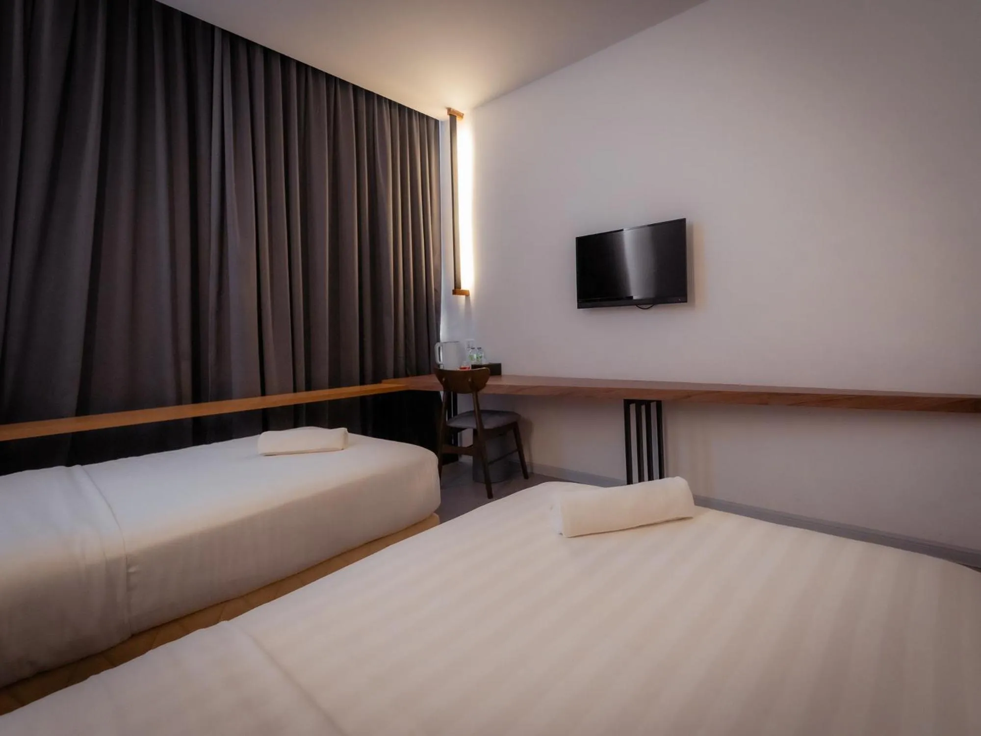 Bed in T+ PREMIUM HOTEL