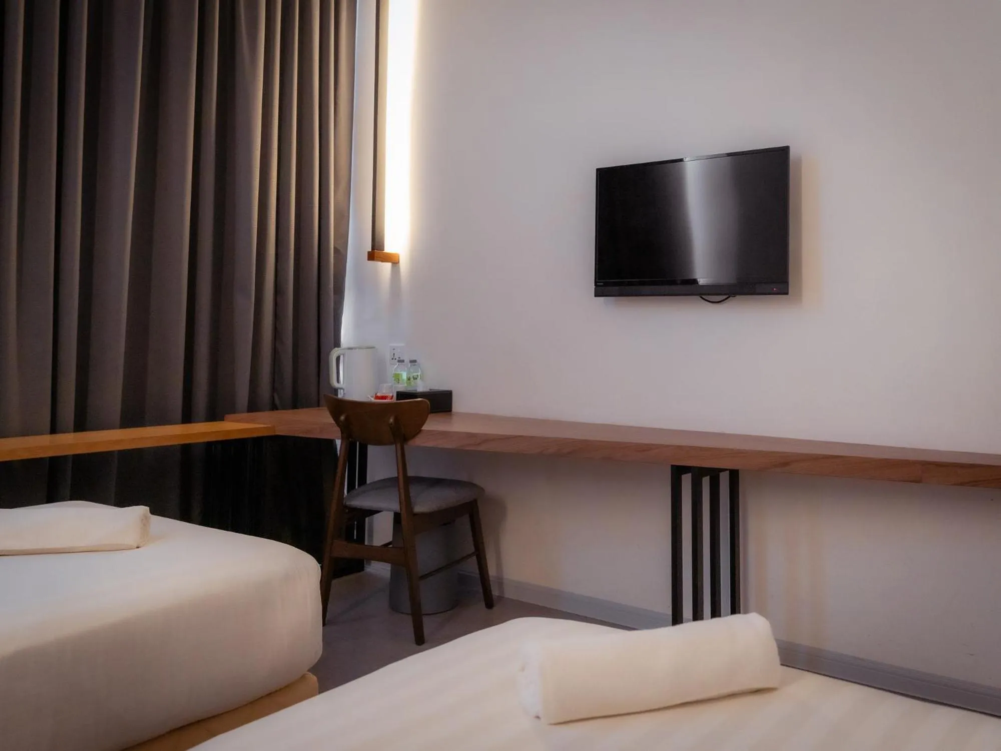 Bed in T+ PREMIUM HOTEL