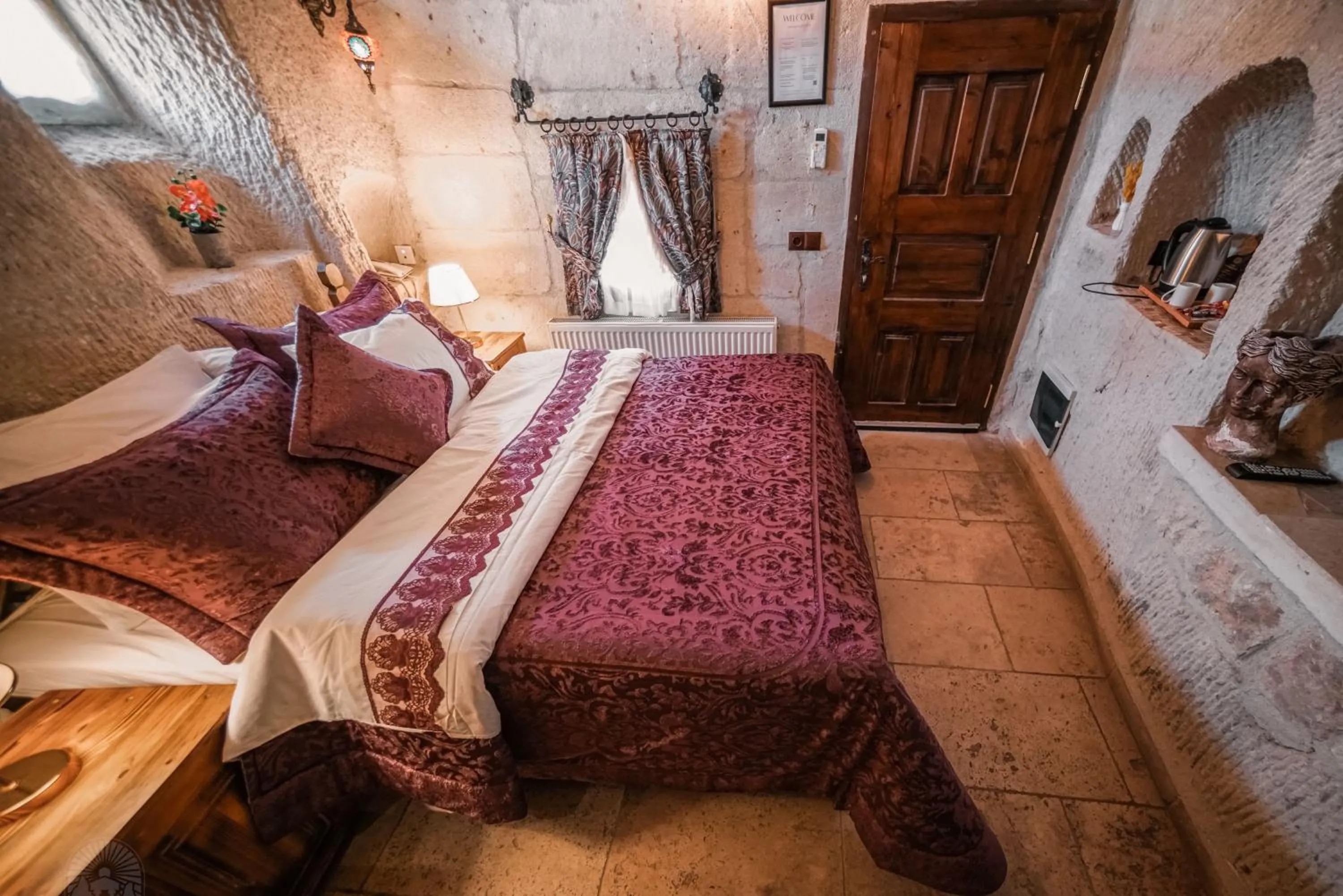 Bed in Zeus Cave Suites
