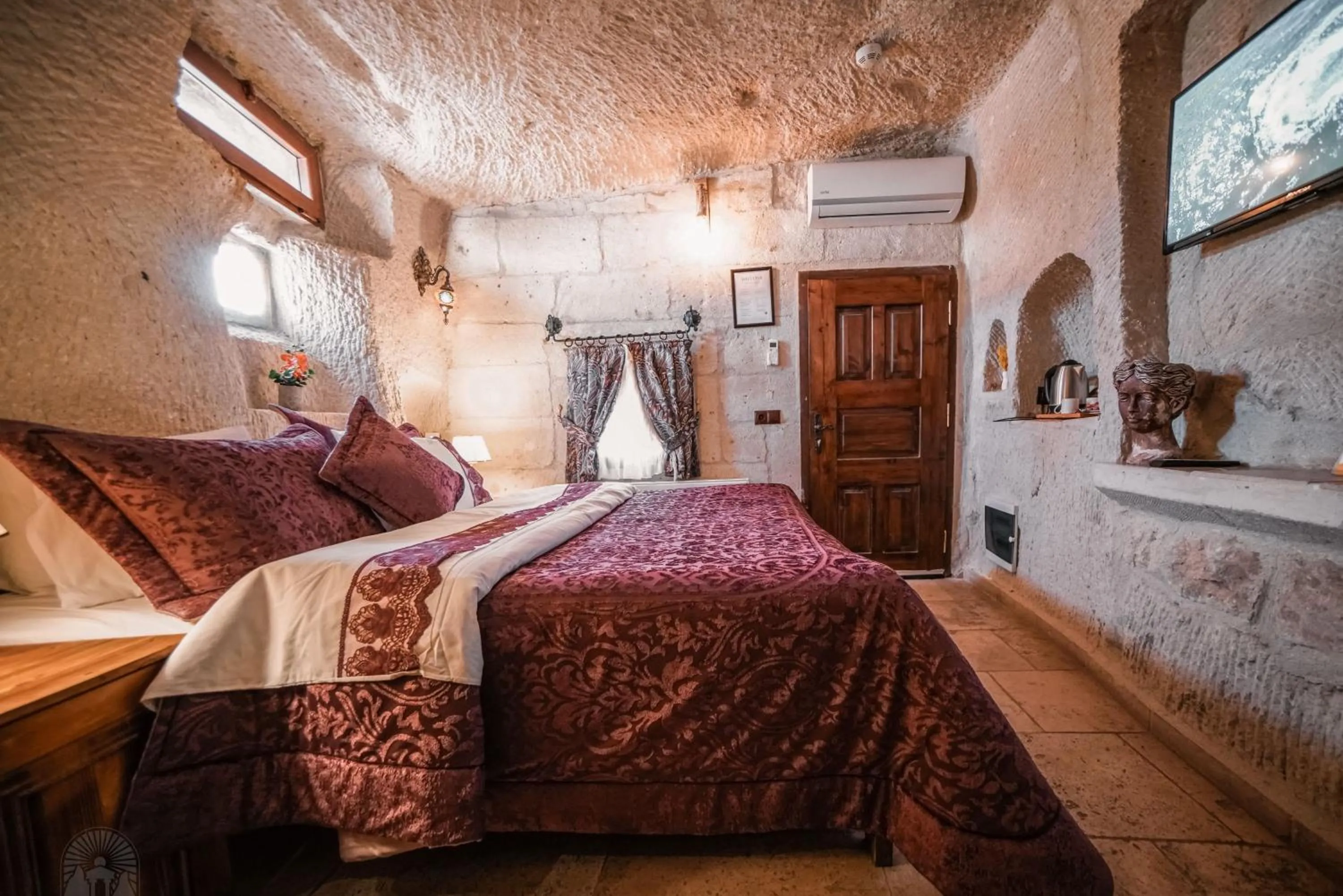 Bed in Zeus Cave Suites