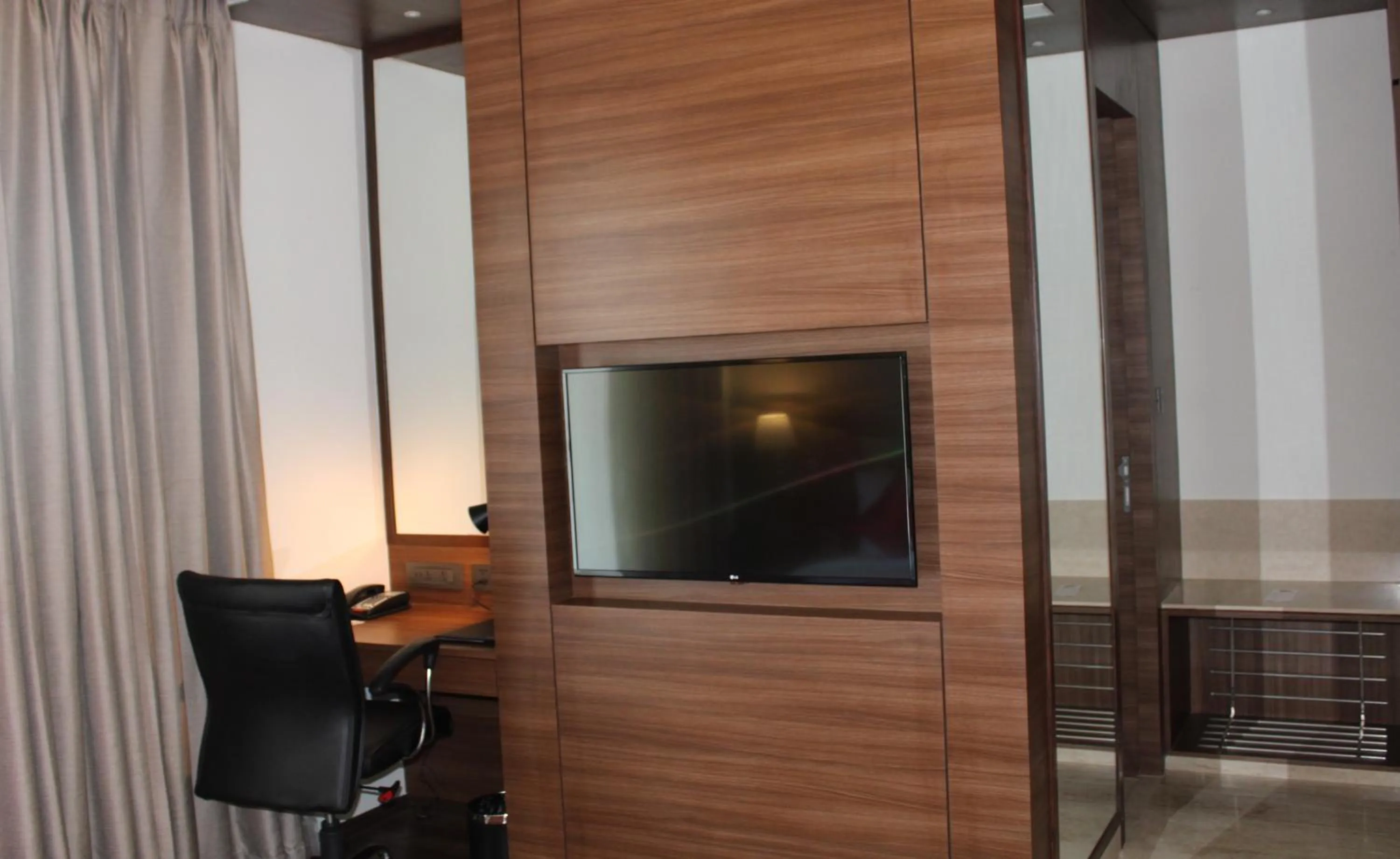 TV and multimedia in Ramada by Wyndham Gandhidham Shinay