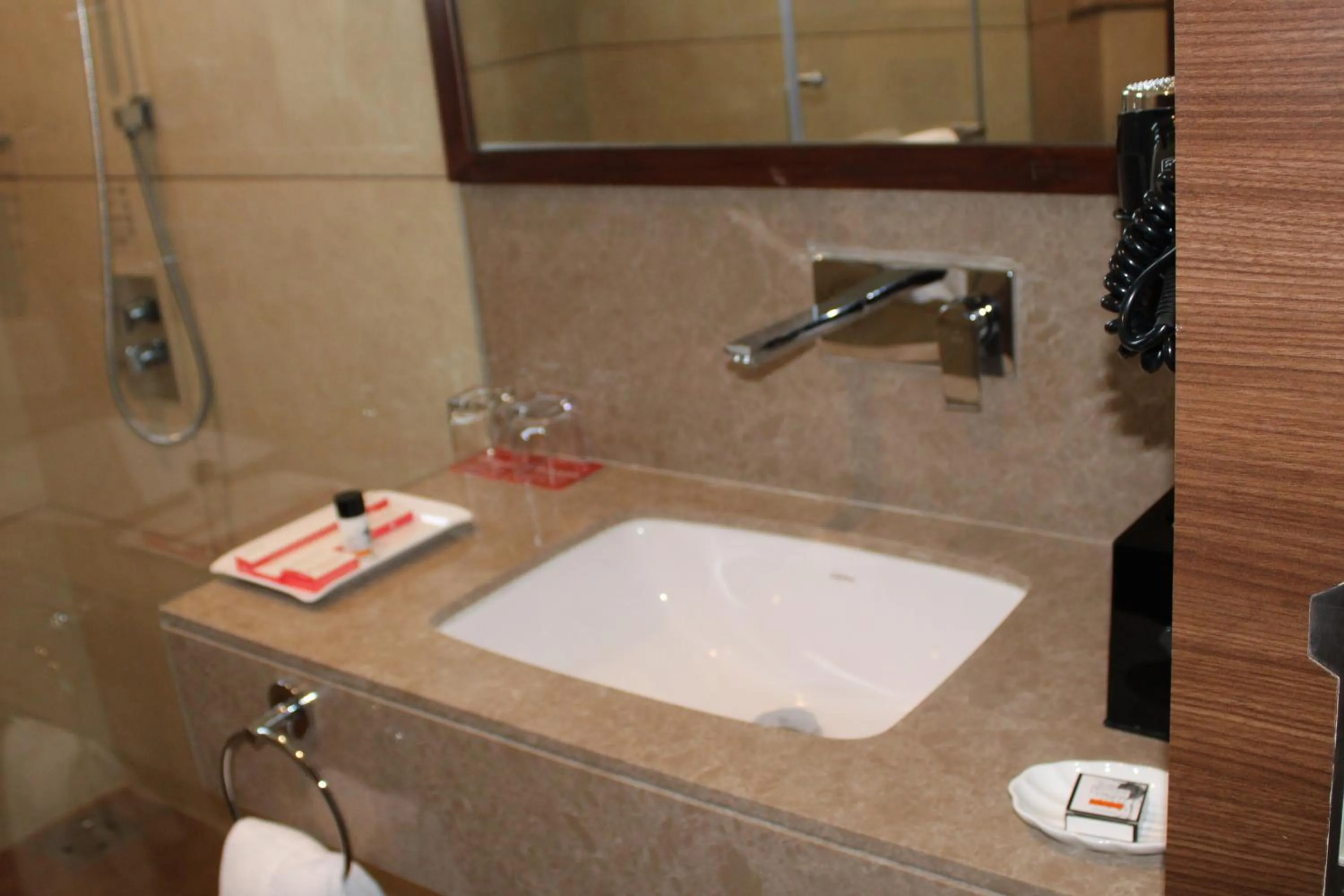 Bathroom in Ramada by Wyndham Gandhidham Shinay