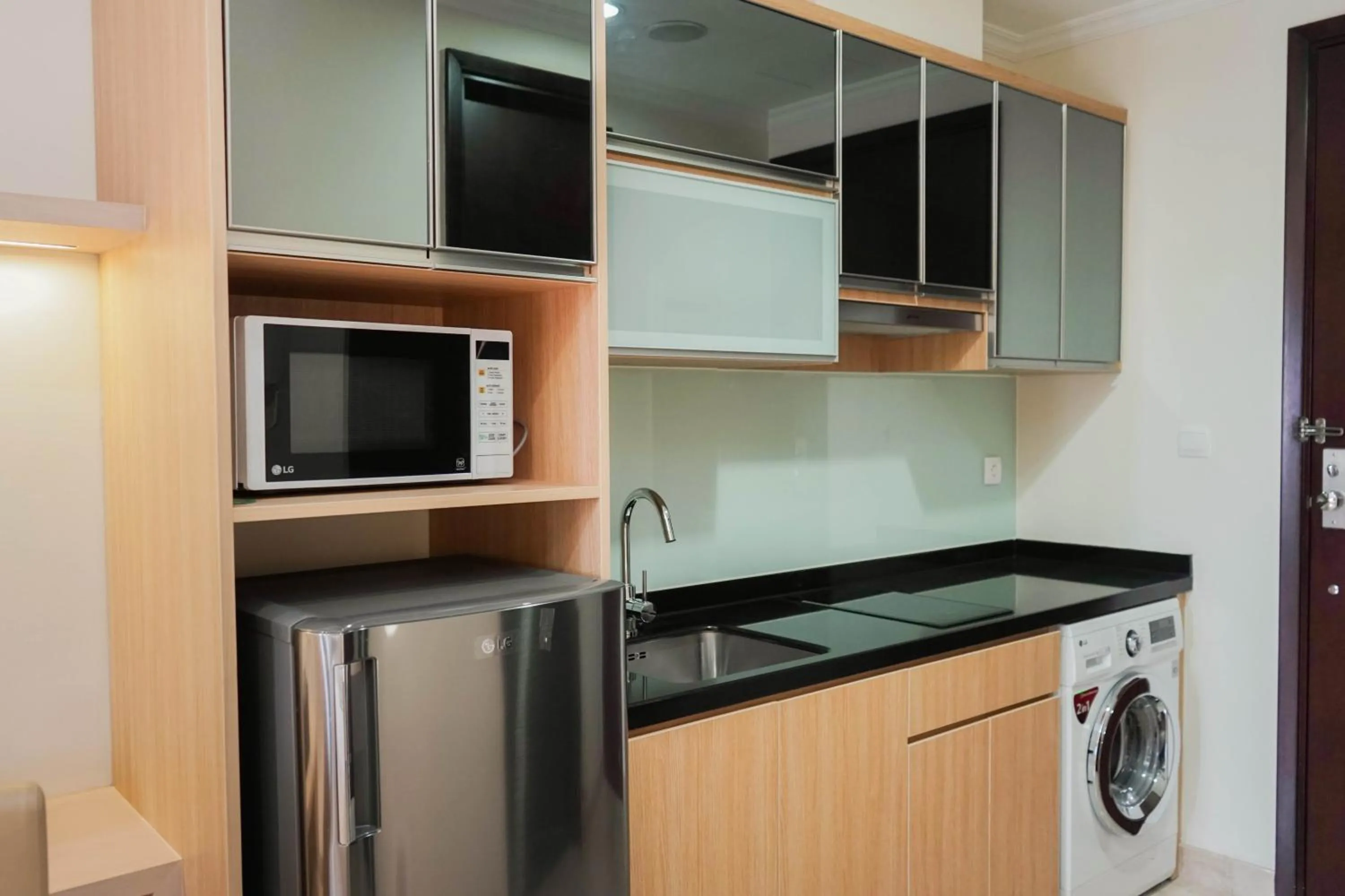 Kitchen or kitchenette in Comfy Studio Apartment at Menteng Park By Travelio