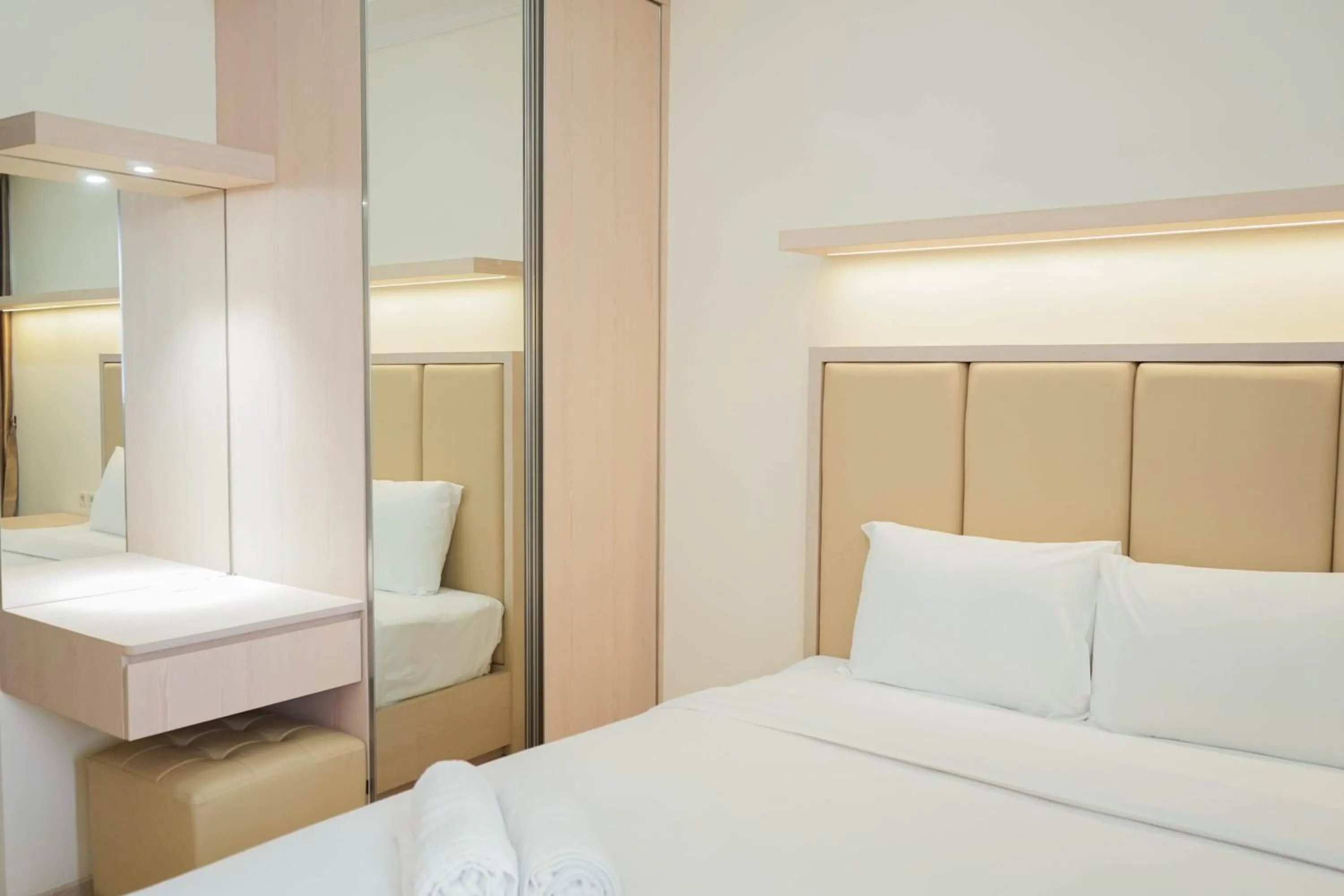 Bed in Comfy Studio Apartment at Menteng Park By Travelio