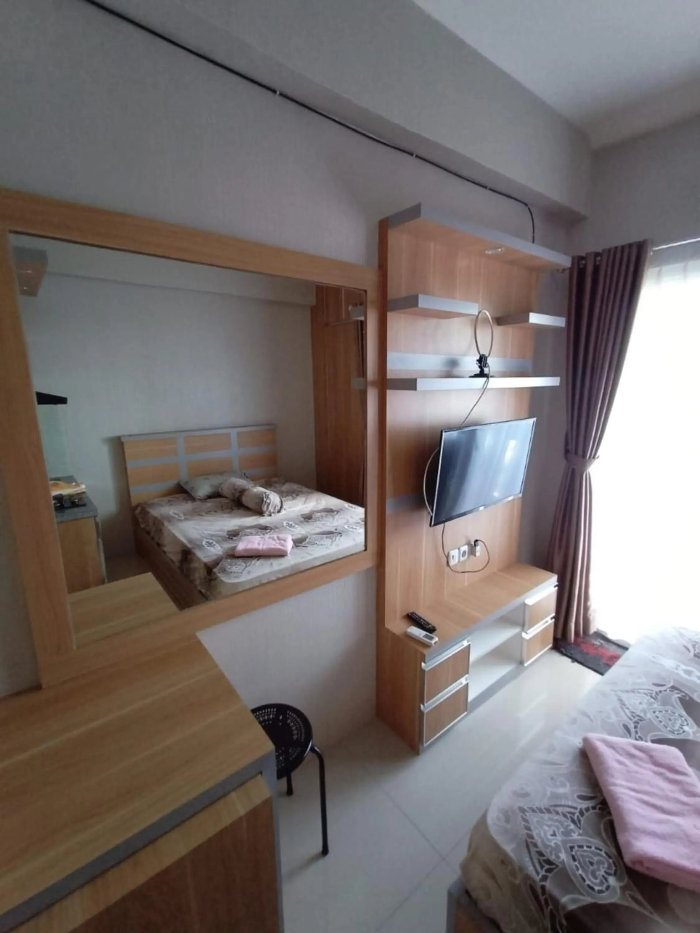 Bed in Apartment Green Pramuka by Vincent