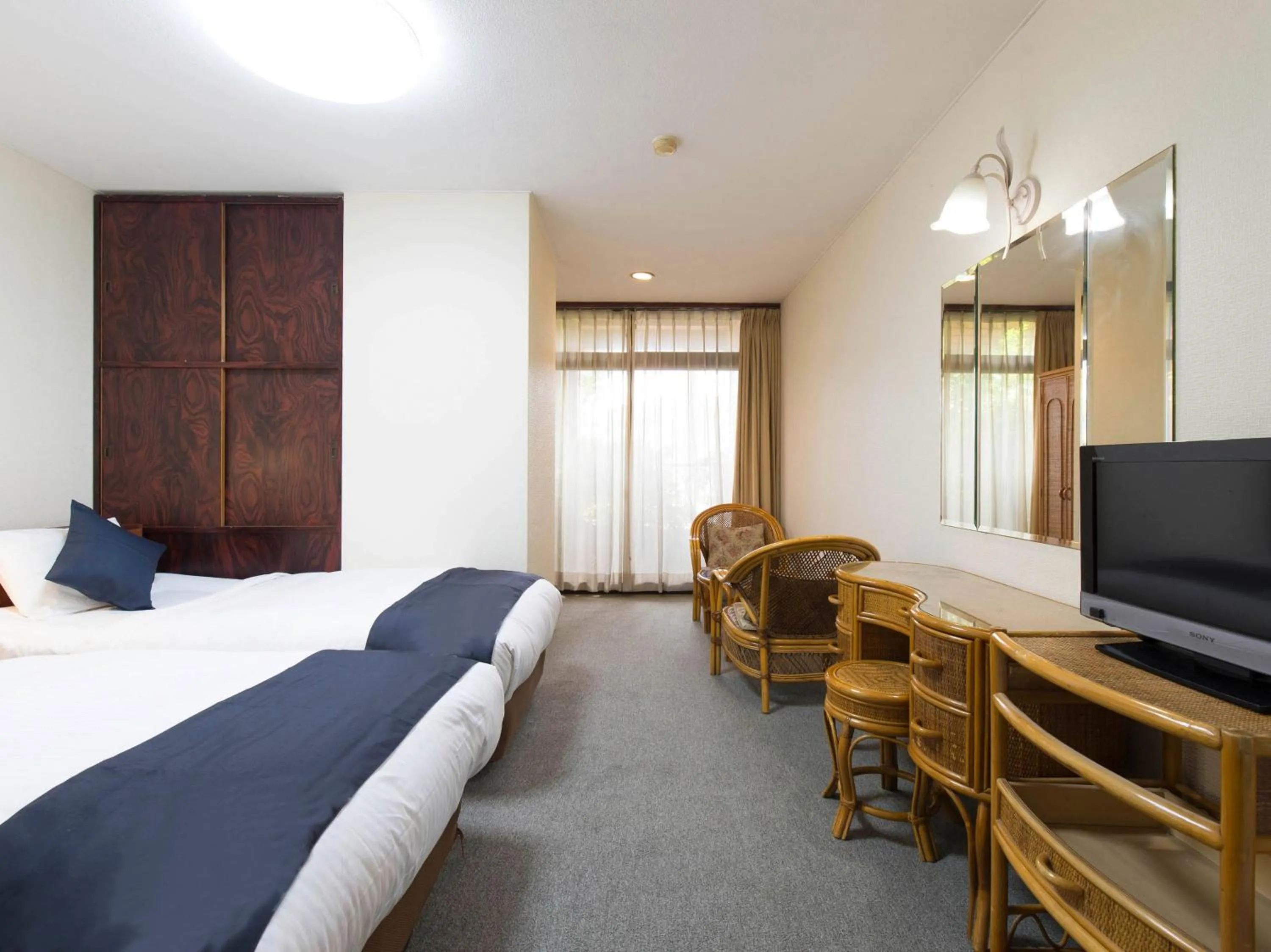 Photo of the whole room, Bed in Tabist New World Hotel Kagoshima Kanoya