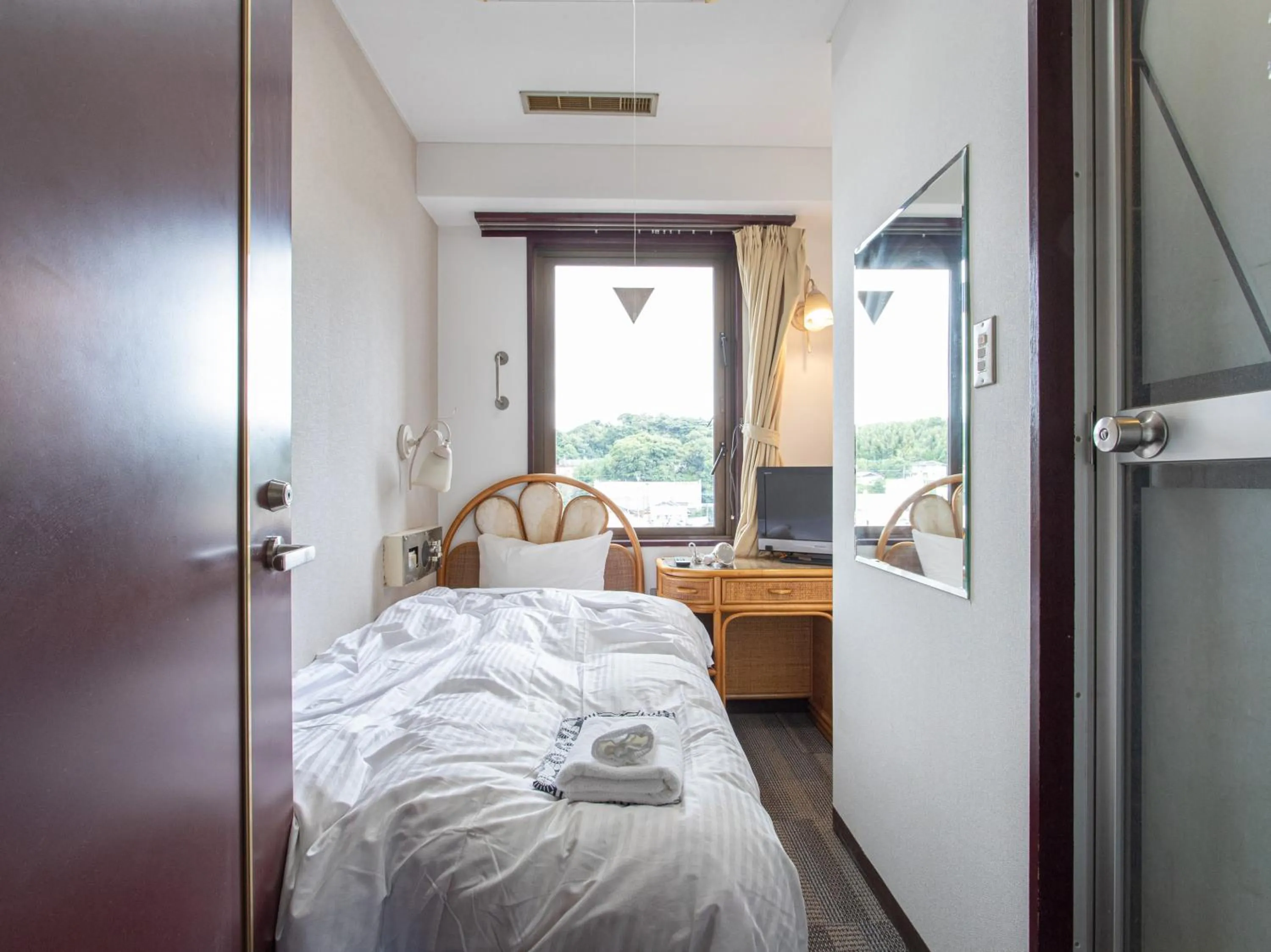 Photo of the whole room, Bed in Tabist New World Hotel Kagoshima Kanoya