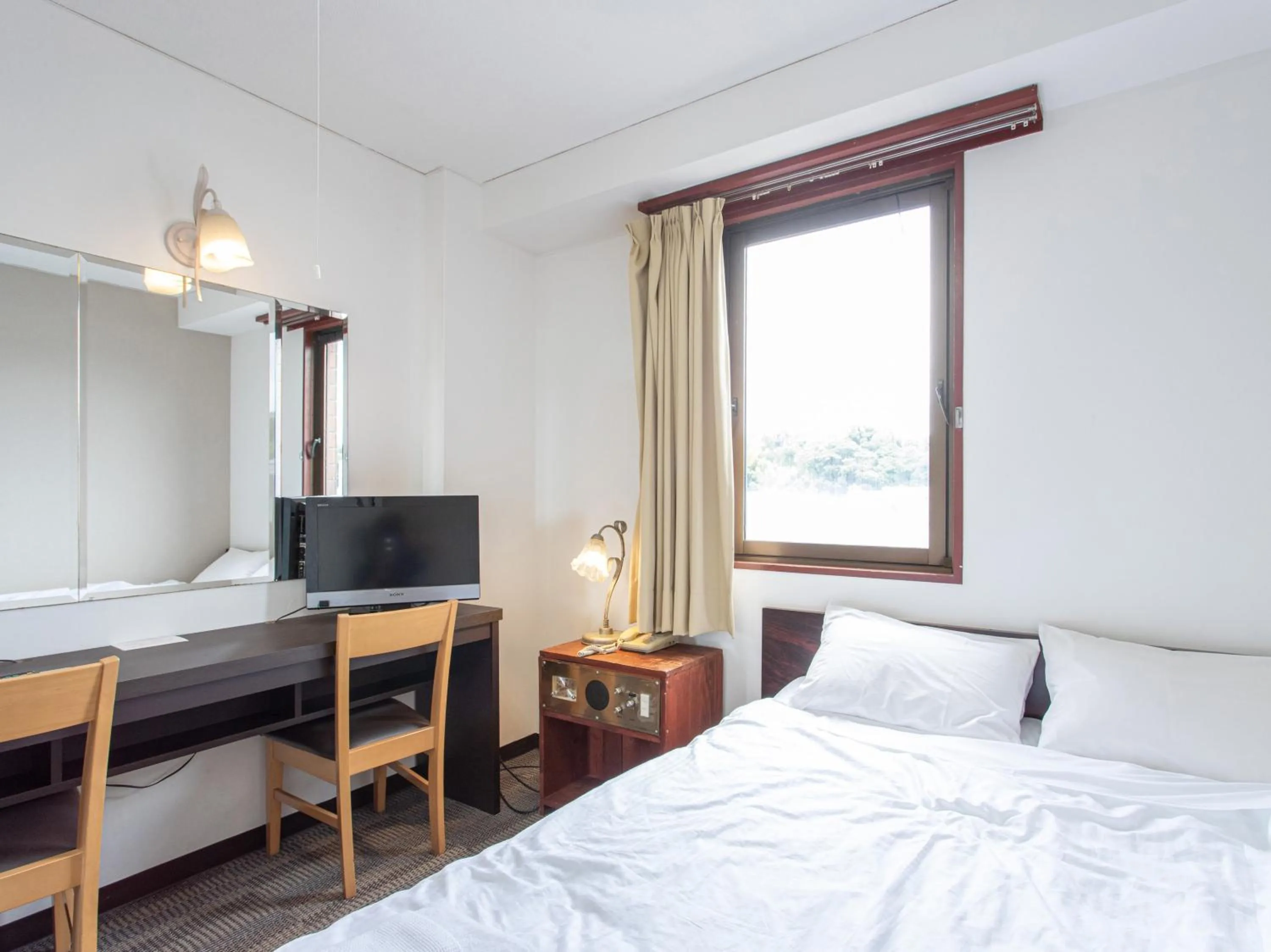 Photo of the whole room, Bed in Tabist New World Hotel Kagoshima Kanoya