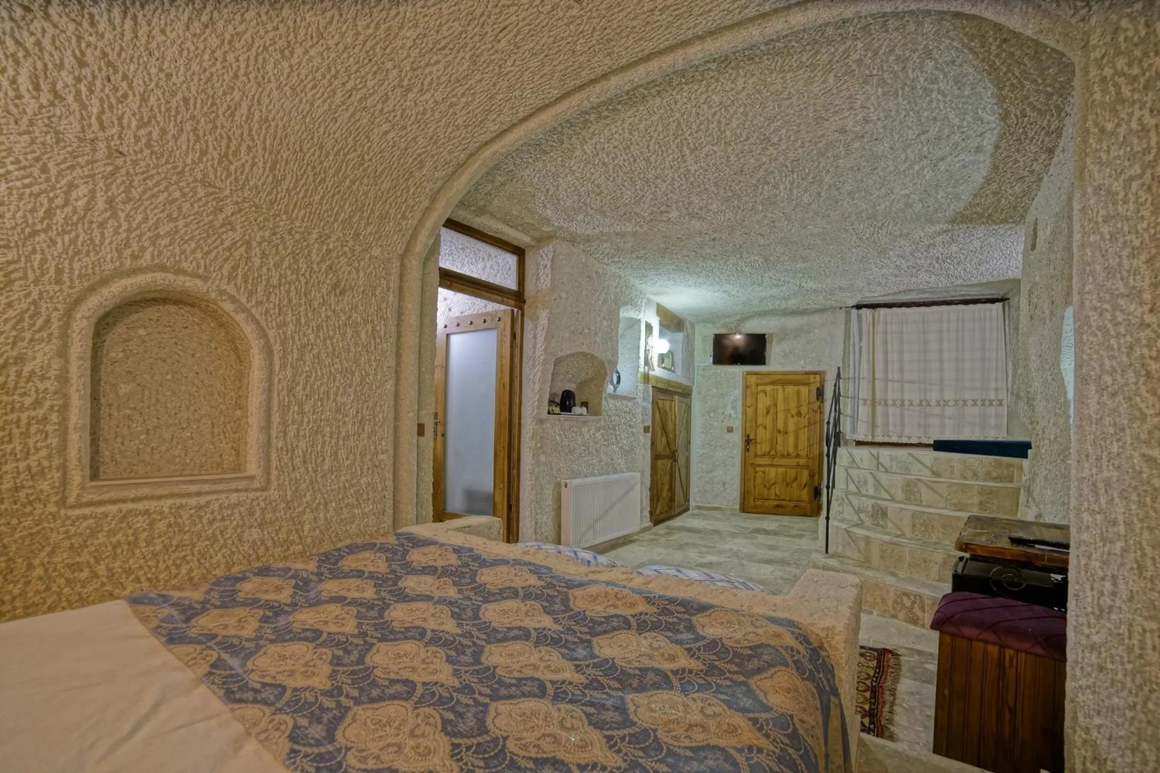 Bed in Risus Cave Suites