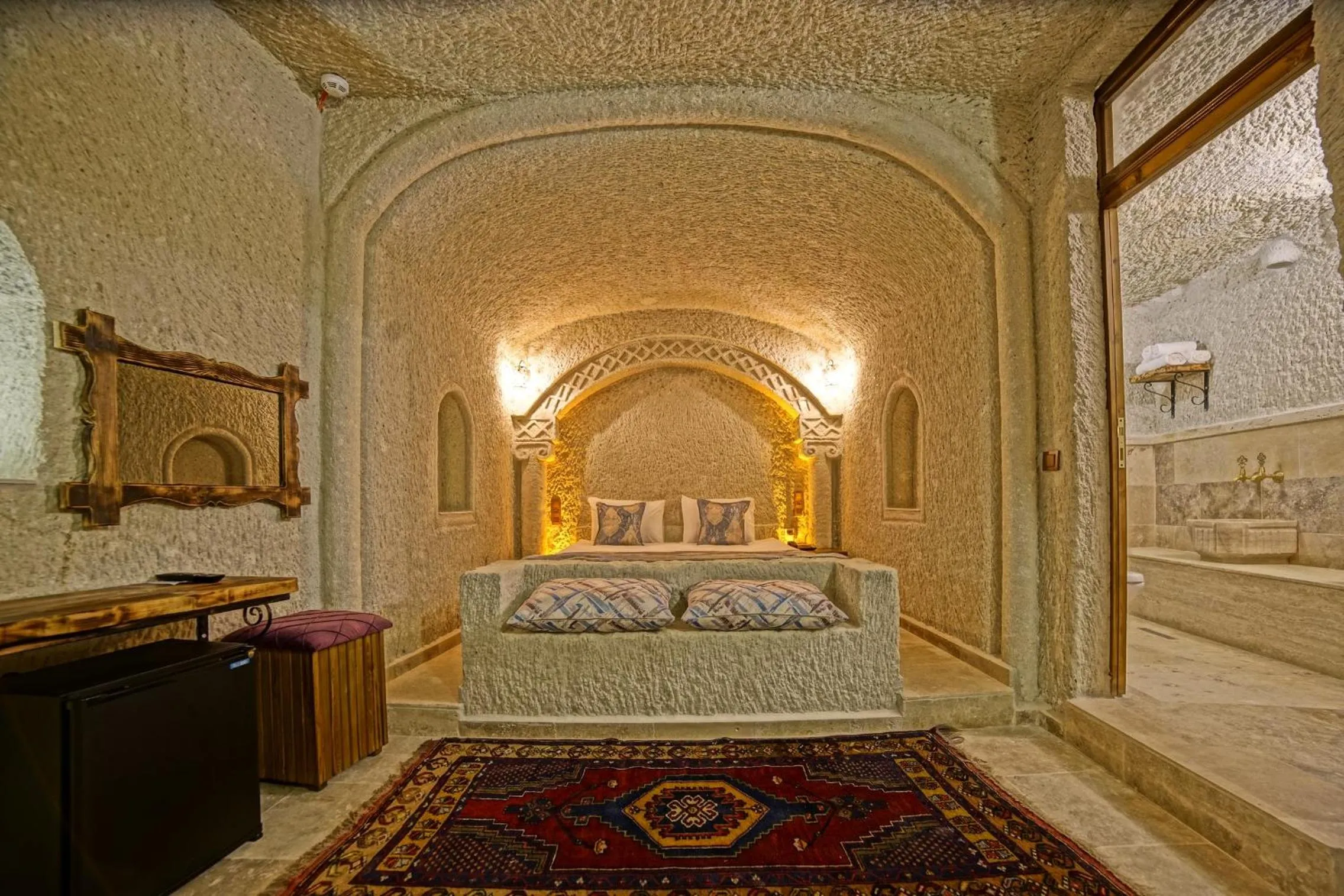 Bed in Risus Cave Suites
