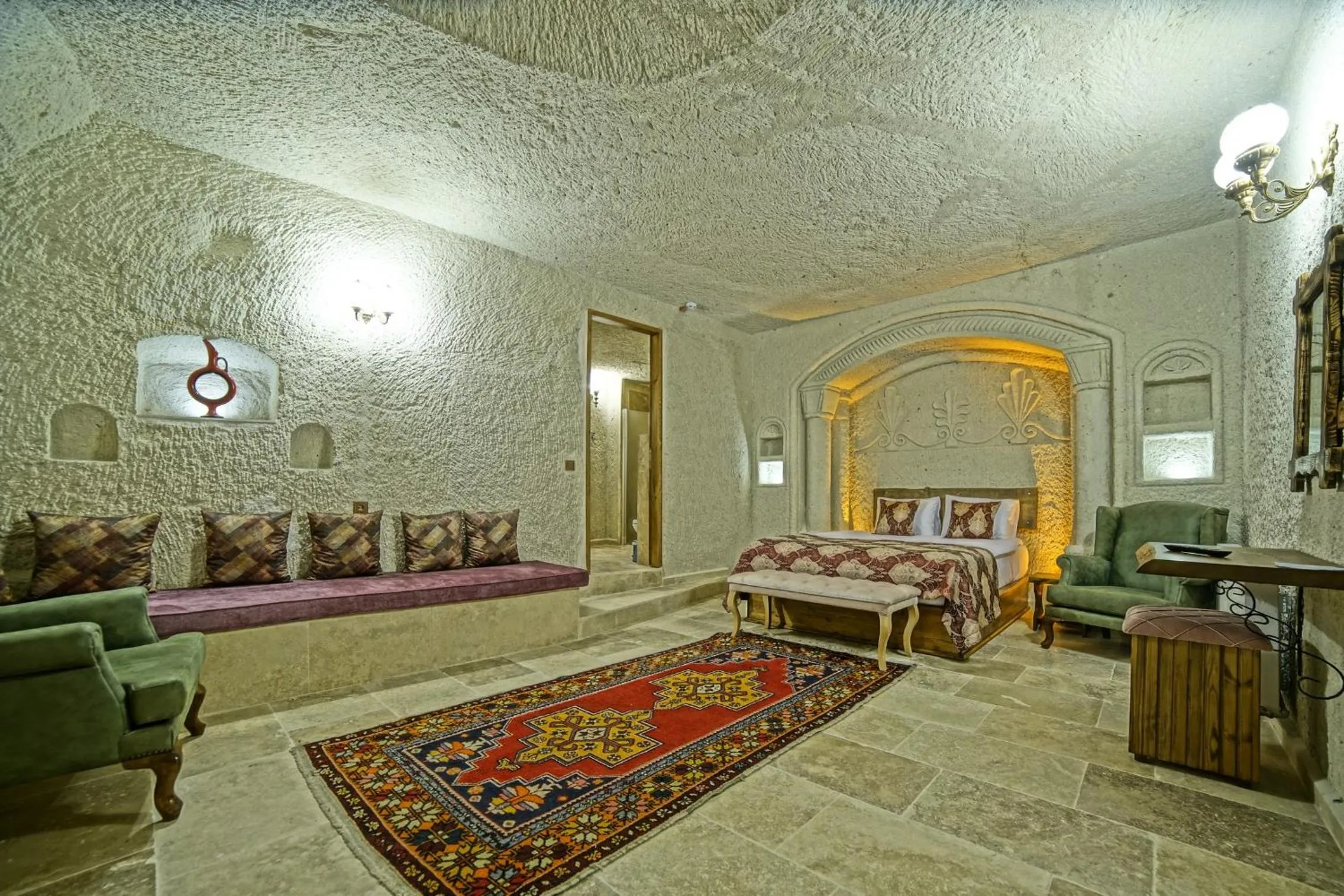 Bed in Risus Cave Suites