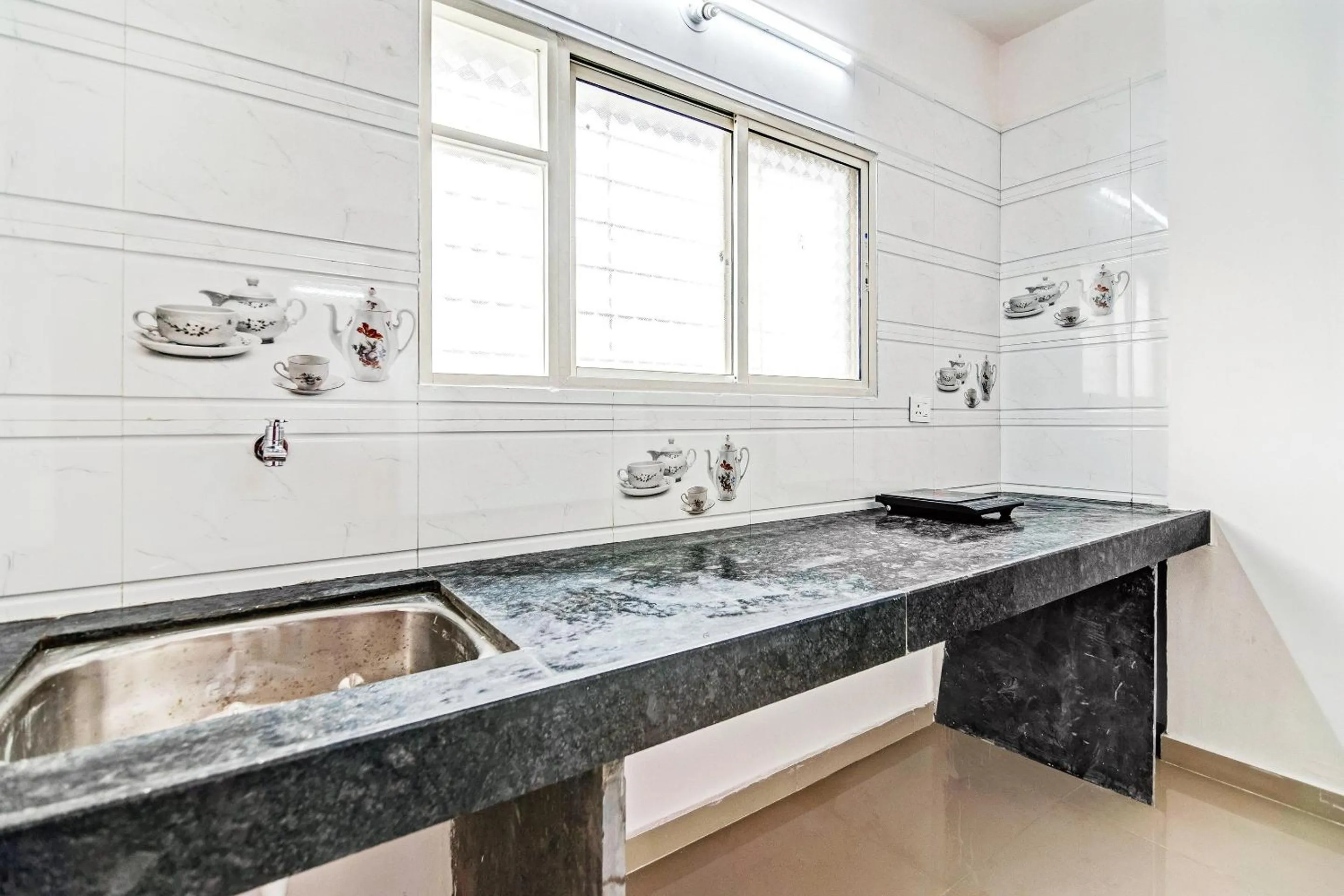 Kitchen or kitchenette in Hotel O Home Elegant RK Fursungi