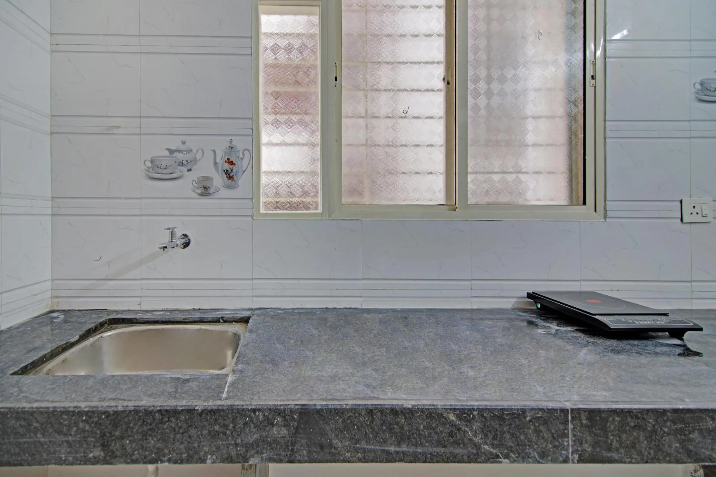 Kitchen or kitchenette in Hotel O Home Elegant RK Fursungi