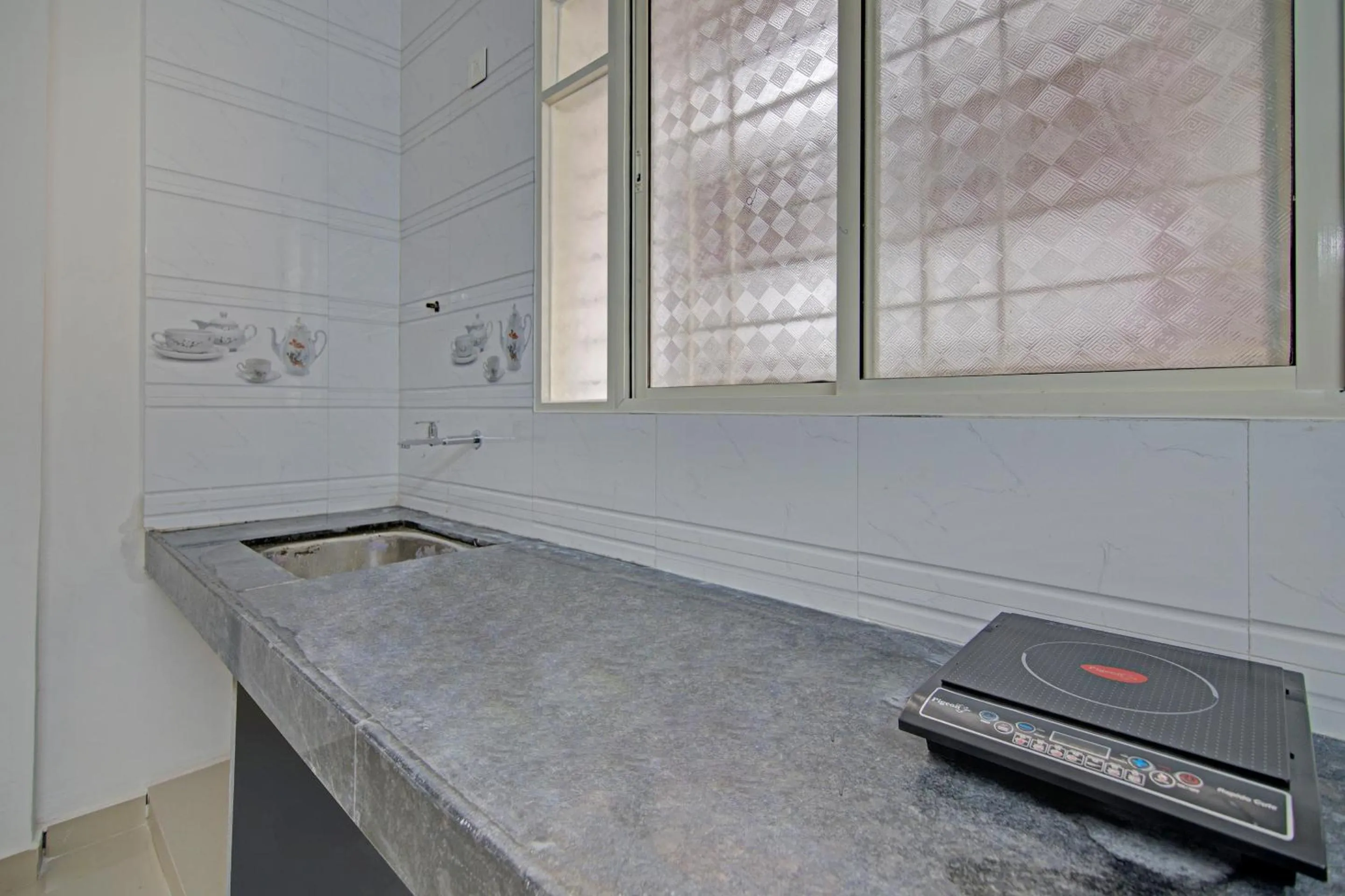 Kitchen or kitchenette in Hotel O Home Elegant RK Fursungi