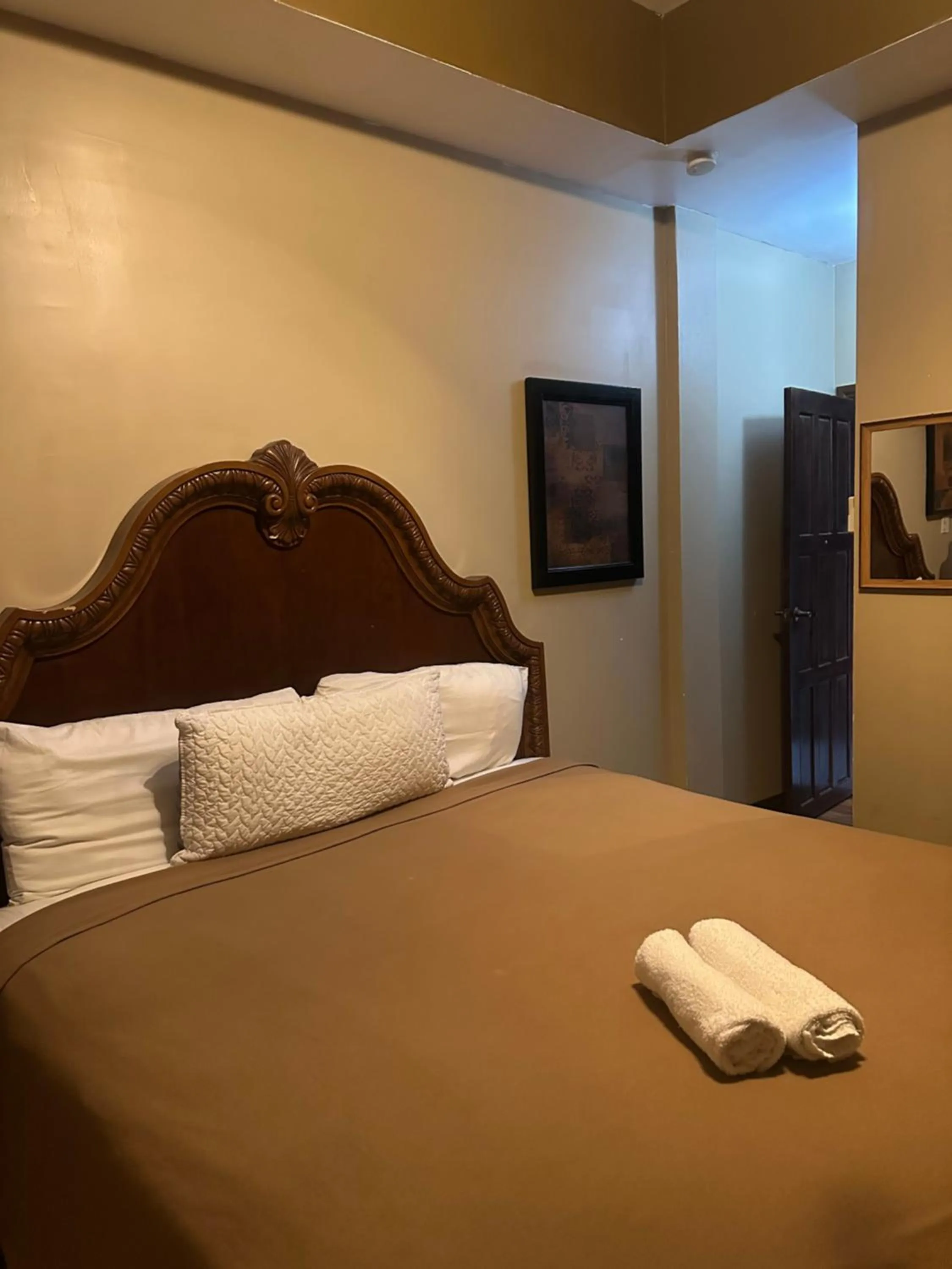 Bed in Hotel Royal Blue & Golf Cart Rental