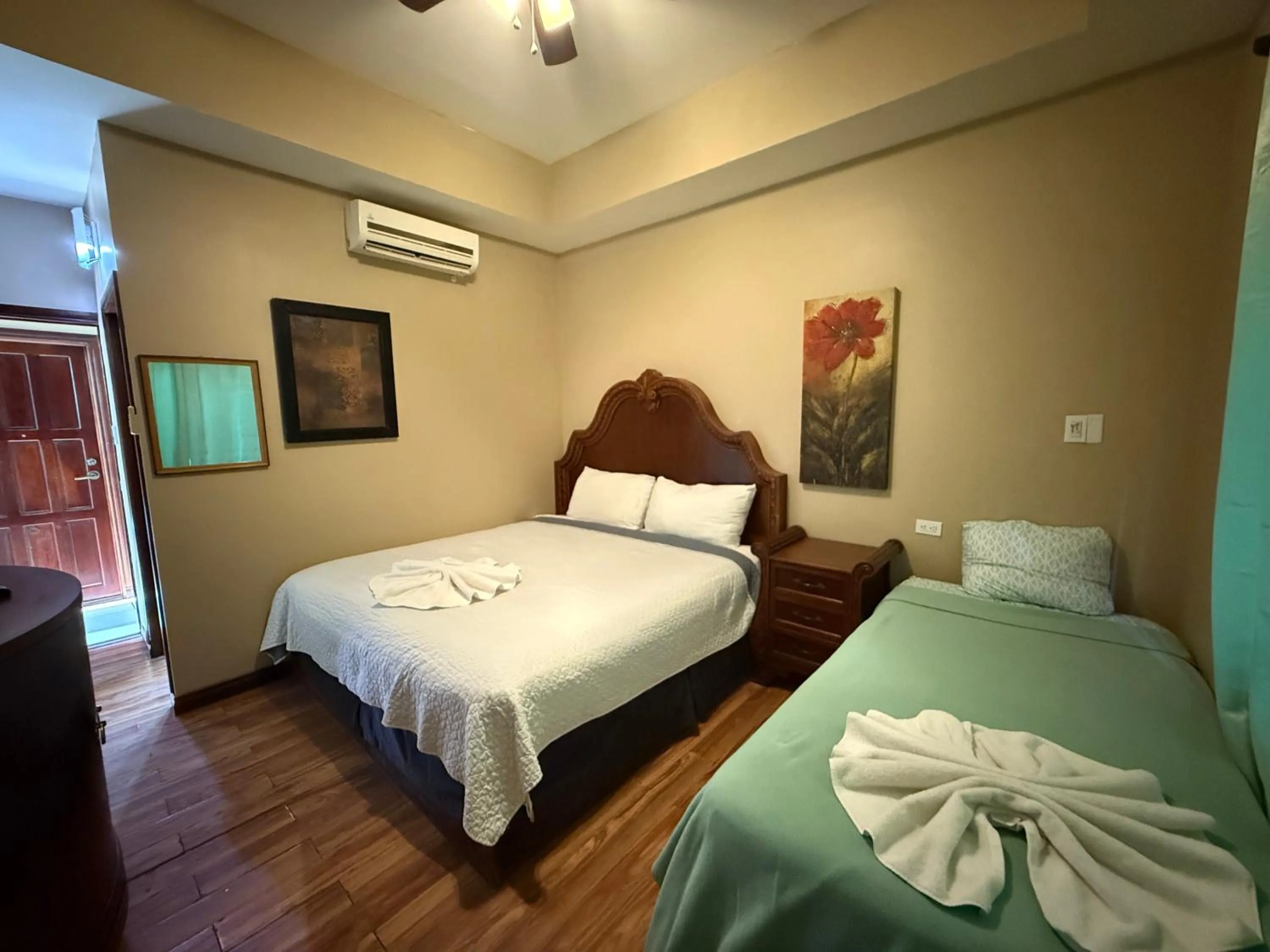 Bed in Hotel Royal Blue & Golf Cart Rental